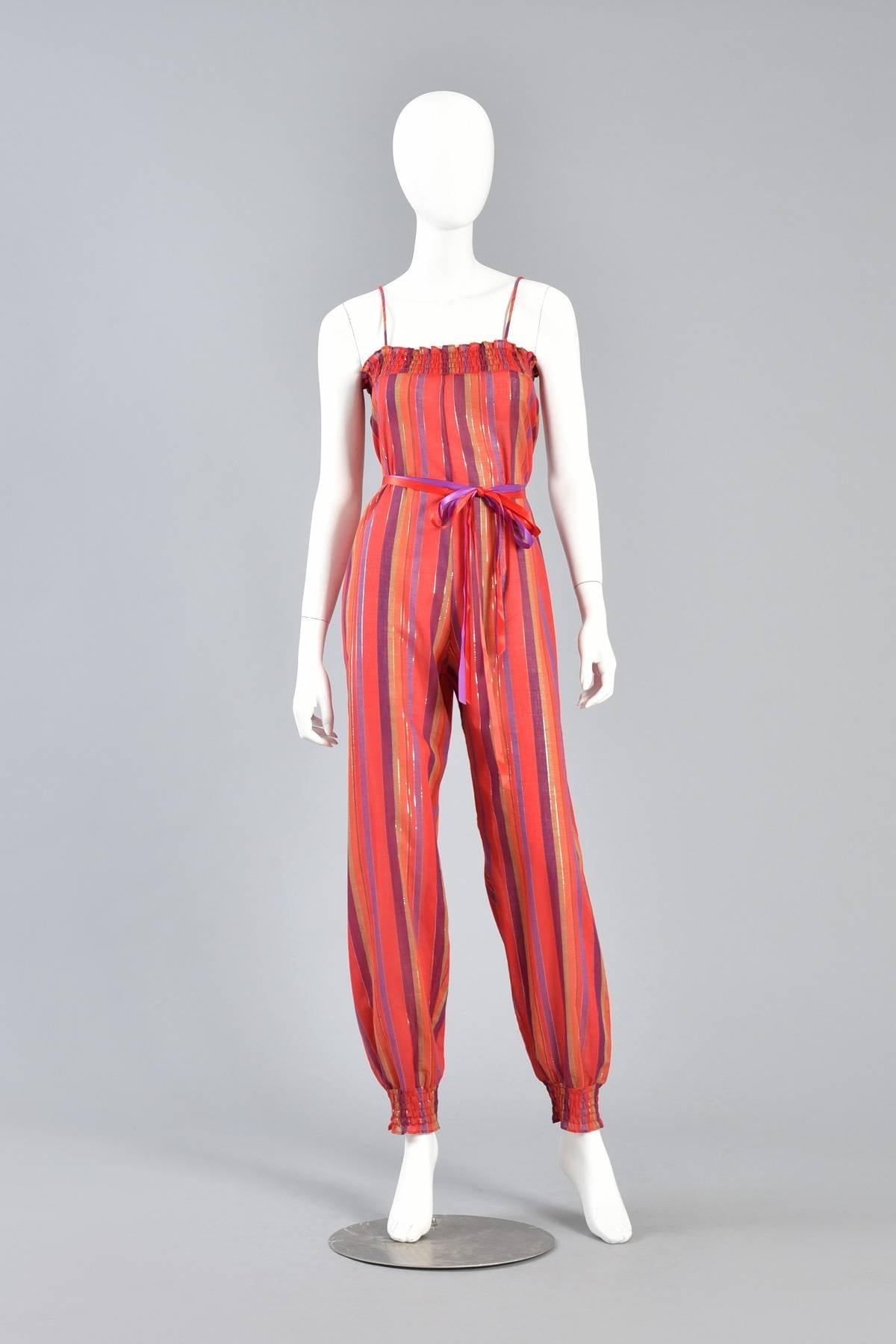 1970s Ethnic Stripe Cotton Gauze Jumpsuit with Lurex Threads

Excellent vintage 1970s ethnic striped cotton jumpsuit. Coveted find! Lightweight semi sheer cotton gauze body with red, purple, gold & orange stripes accented by silver and gold lurex