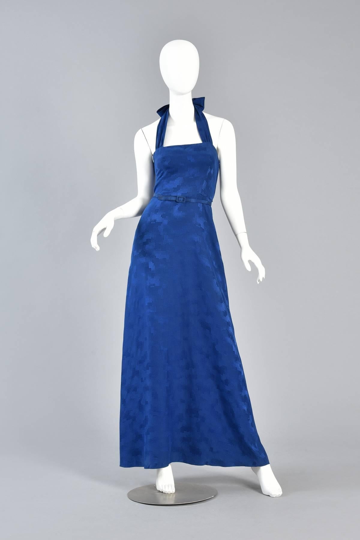 Lovely vintage 1980s lapis blue silk gown with halter neckline - a perfectly simple & chic piece for just about any occasion. Classic fitted bodice with wide ribbon-like halter straps and flared skirt. Amazing tone on tone pixelated cloud pattern.