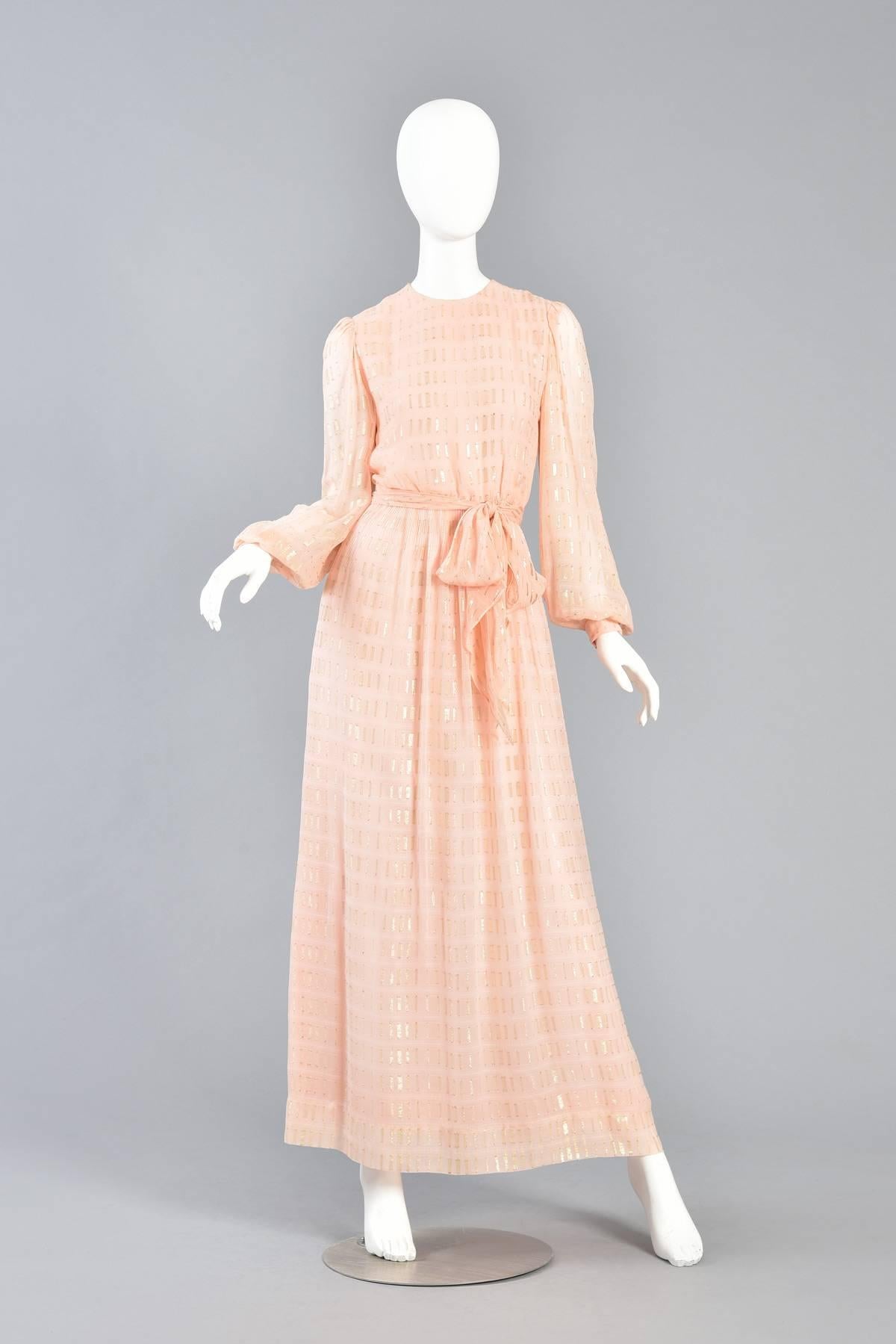 1960s Nat Kaplan Couture Peach Silk Dress with Gold Lurex Threads Throughout

Stunning 1960s silk dress by Nat Kaplan Couture. Pale peach silk chiffon with gold lurex threads running throughout. Class 1960s cut body with gathered skirt with nipped