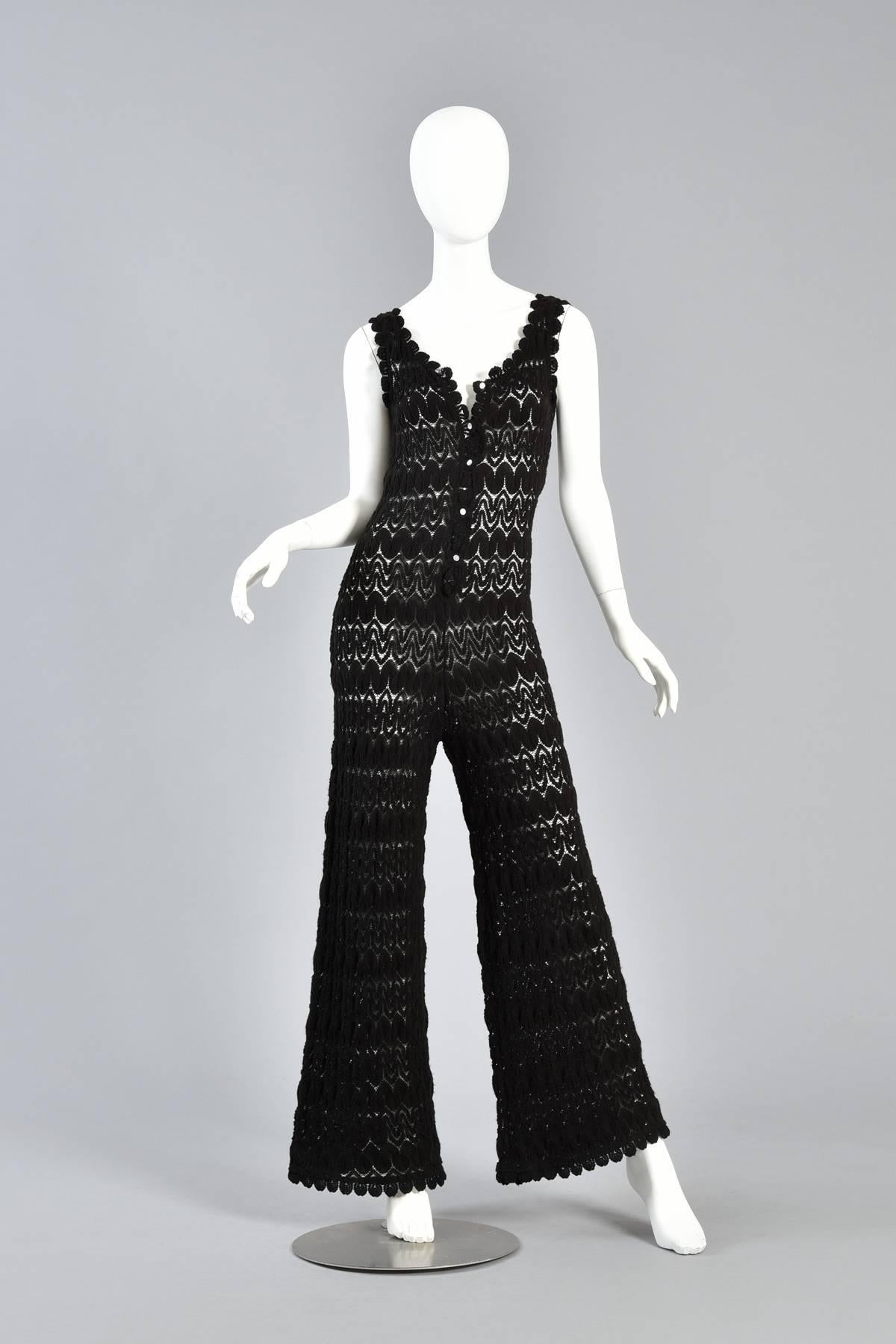 Exceptional vintage 1960s black hand crocheted/knit jumpsuit. Insanely awesome find! Lightweight and super soft black acrylic knit body with zigzagging chevron pattern. Button up front with tiny pearly buttons and scalloped neckline. Tightly fitted