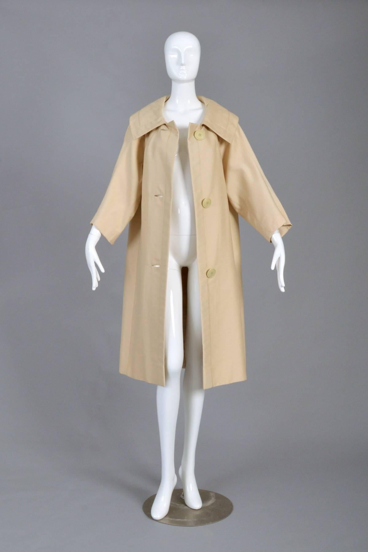 Stunning vintage 1950s silk coat by Christian Dior for Christian Dior Originals, NY. Light oatmeal colored raw silk (Color is slightly off in photos. Photo of the label is closest to actual color). Oversized buttons. Incredible topstitched details,