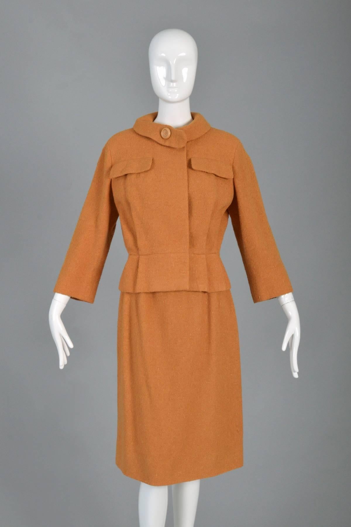 Perfect vintage mid-to-late 60s skirt suit by Marc Bohan for Christian Dior New York. Fantastic pumpkin/terra cotta nubby wool fabric with silk lining. Pleat front jacket with nipped waist + super cute breast pockets. Double fold tab collar with