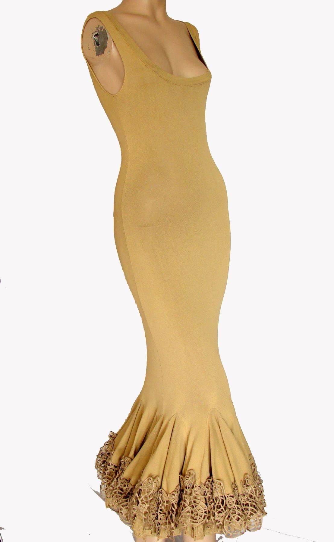 This fabulous Cavalli dress is made from a body-hugging jersey knit in a light tan shade.  The mermaid ruffle hem is incredible and features three rows of knit, netting and leatherette detailing.  Note that this dress is HEAVY at the bottom, but