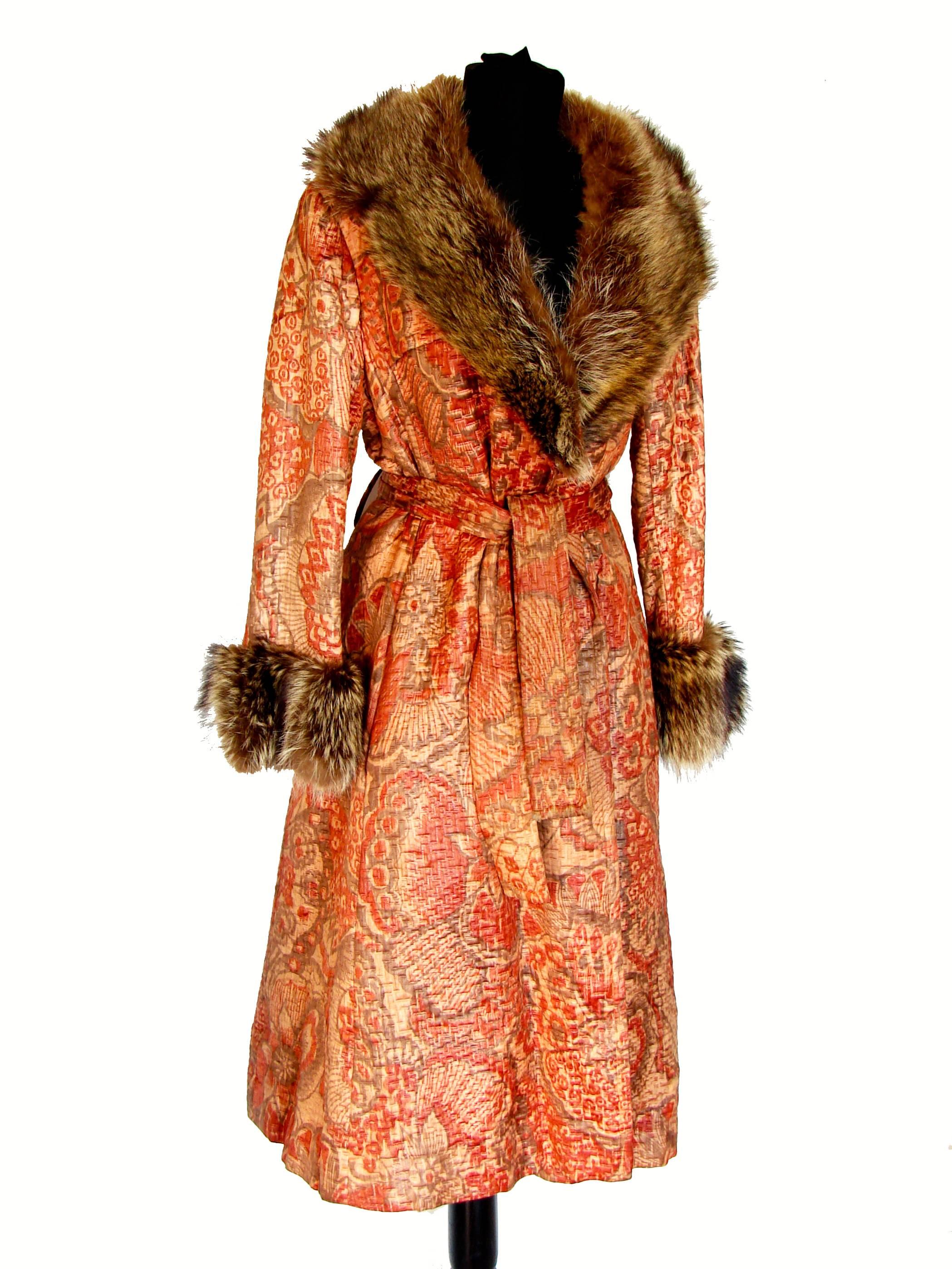 This hard to find textured silk coat with raccoon fur trim by Bill Blass for Bond Street dates to the early 70s.  Made from the most supple textured silk in shades of coral, taupe and beige, it features a wide raccoon fur collar and matching trimmed