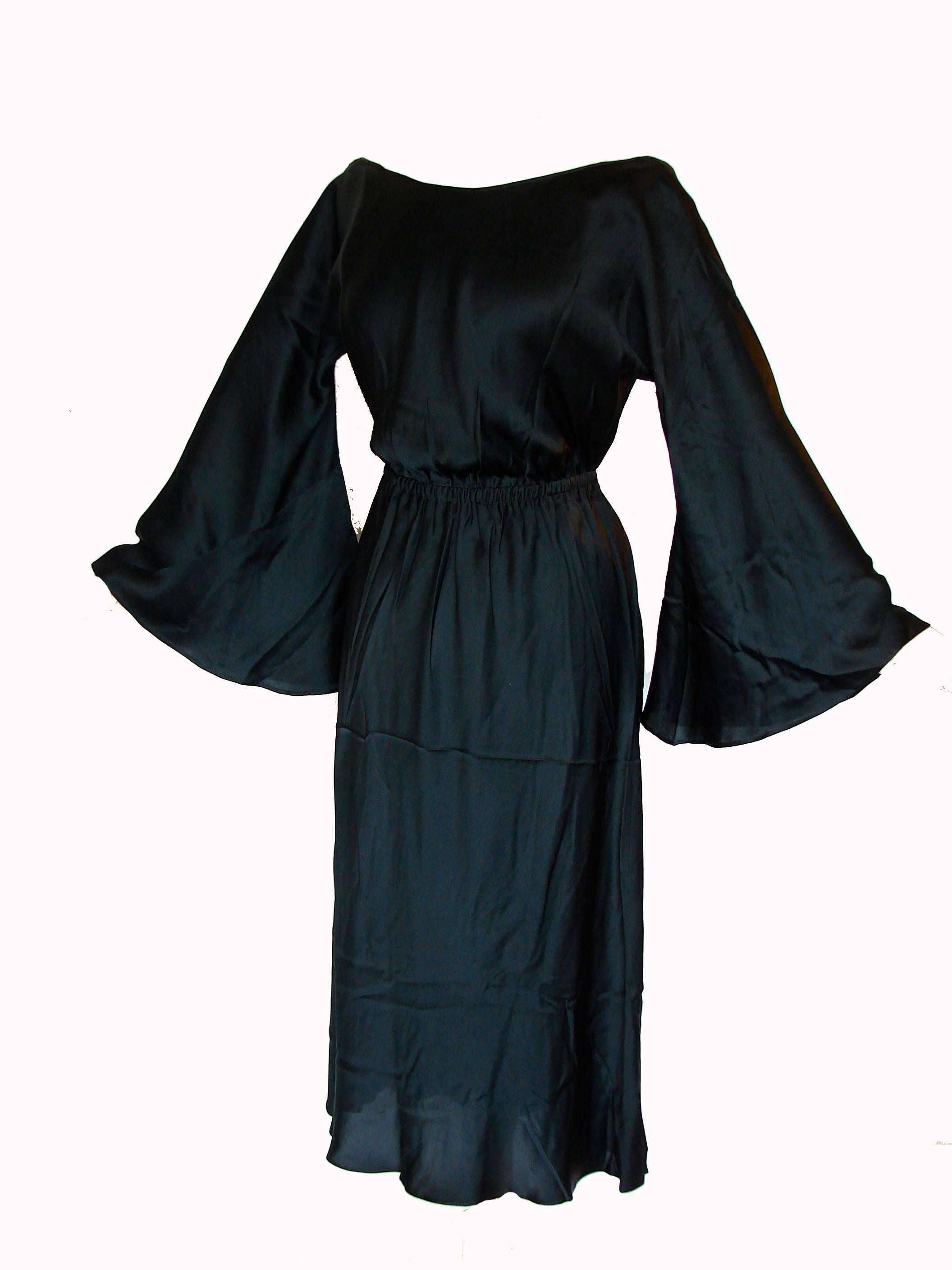 Here's an incredible silk Charmeuse evening dress made by Halston in the 1970s.  This gorgeous dress features incredibly large bell sleeves (38in around), an elasticized waist and a sexy low-cut back.  Simple and sophisticated, yet very sexy.  In