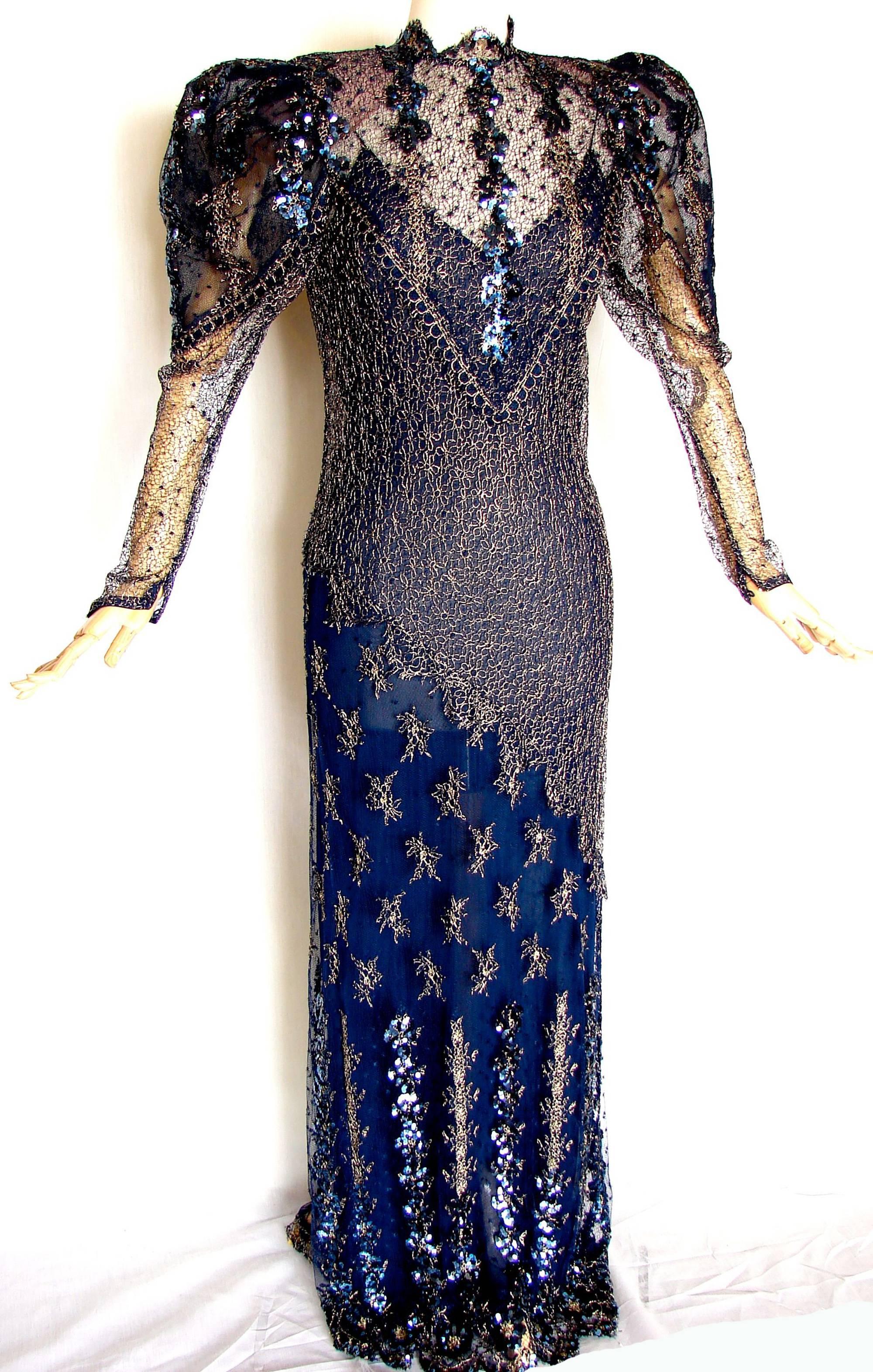This lovely evening dress features two pieces: a navy slip dress and an incredible over dress made from lace, sequins and gold metallic embroidery.  With its Gigot sleeves and rear train, it definitely gives off a vibe of royalty!
In excellent