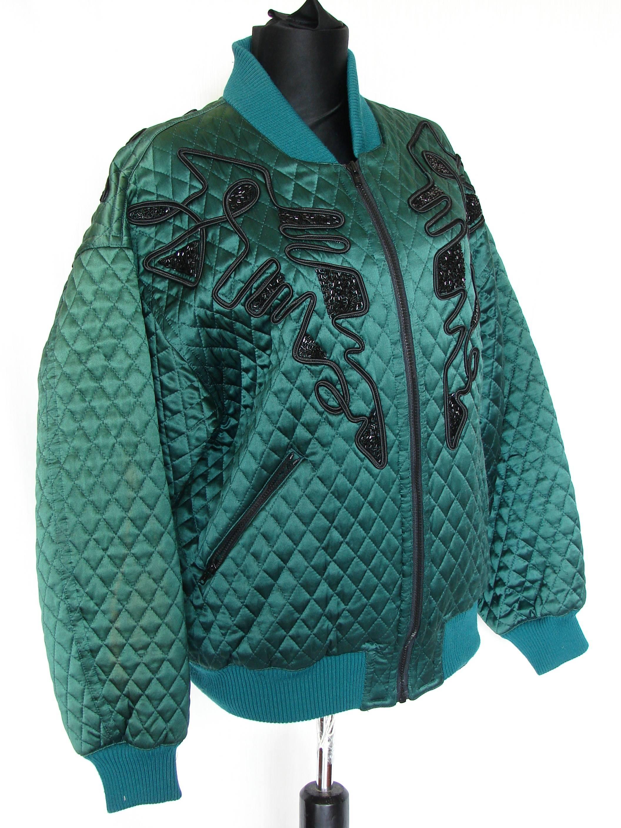 This emerald silk jacket with black bead design by Kansai Yamamoto was made in the 1980s.  In good condition overall, we note one area of fading on the back, left side of the jacket, measuring appx .5