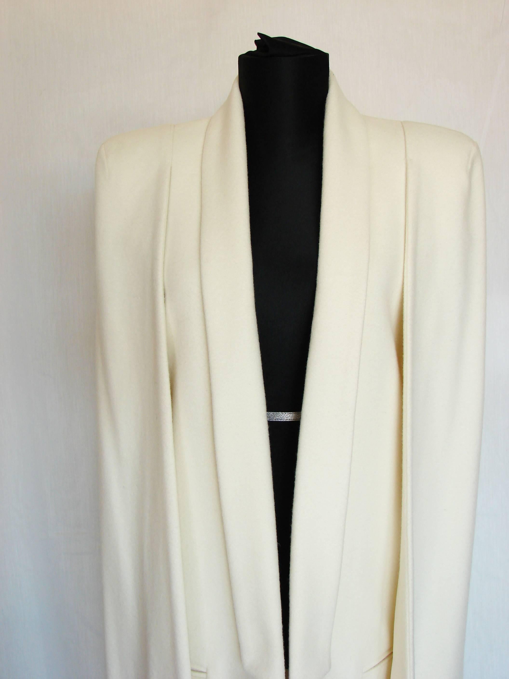 This incredible cape coat was designed by Olcay Gulsen for the 2015 collection.  Features incredible construction and fully lined.  In new with tags condition, there is one defect that we've noted - a small pin-size hole and some very light rubs to