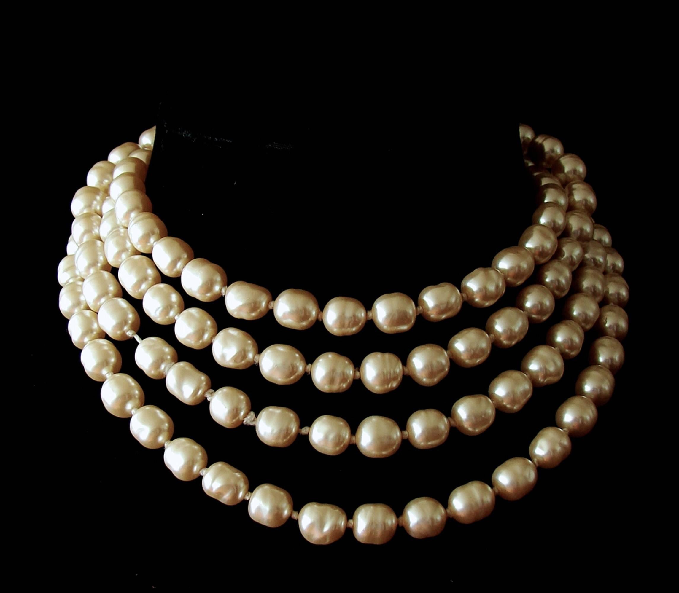 Here's an amazing single pearl strand infinity necklace from CHANEL that measures a whopping 65in long! In excellent condition overall with only minor signs of use - one silk cord knot has very minor fraying and impacts the pearl spacing depending