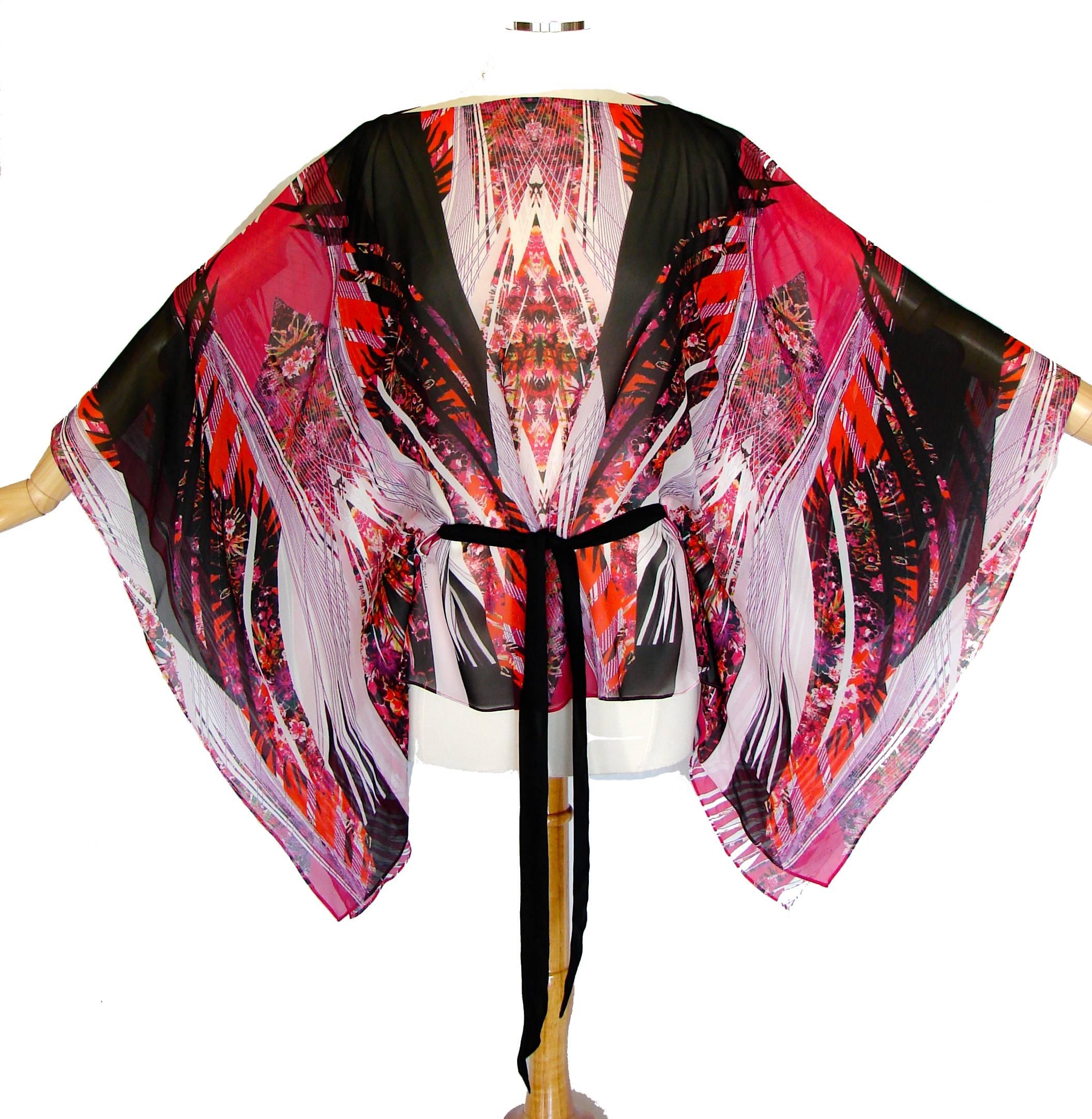 This gorgeous kaftan cape blouse is from Roberto Cavalli and features a colorful print in shades of pink, black and white - so chic! In excellent condition, the designer label is missing, however the fabric is signed with Cavalli's name. No size