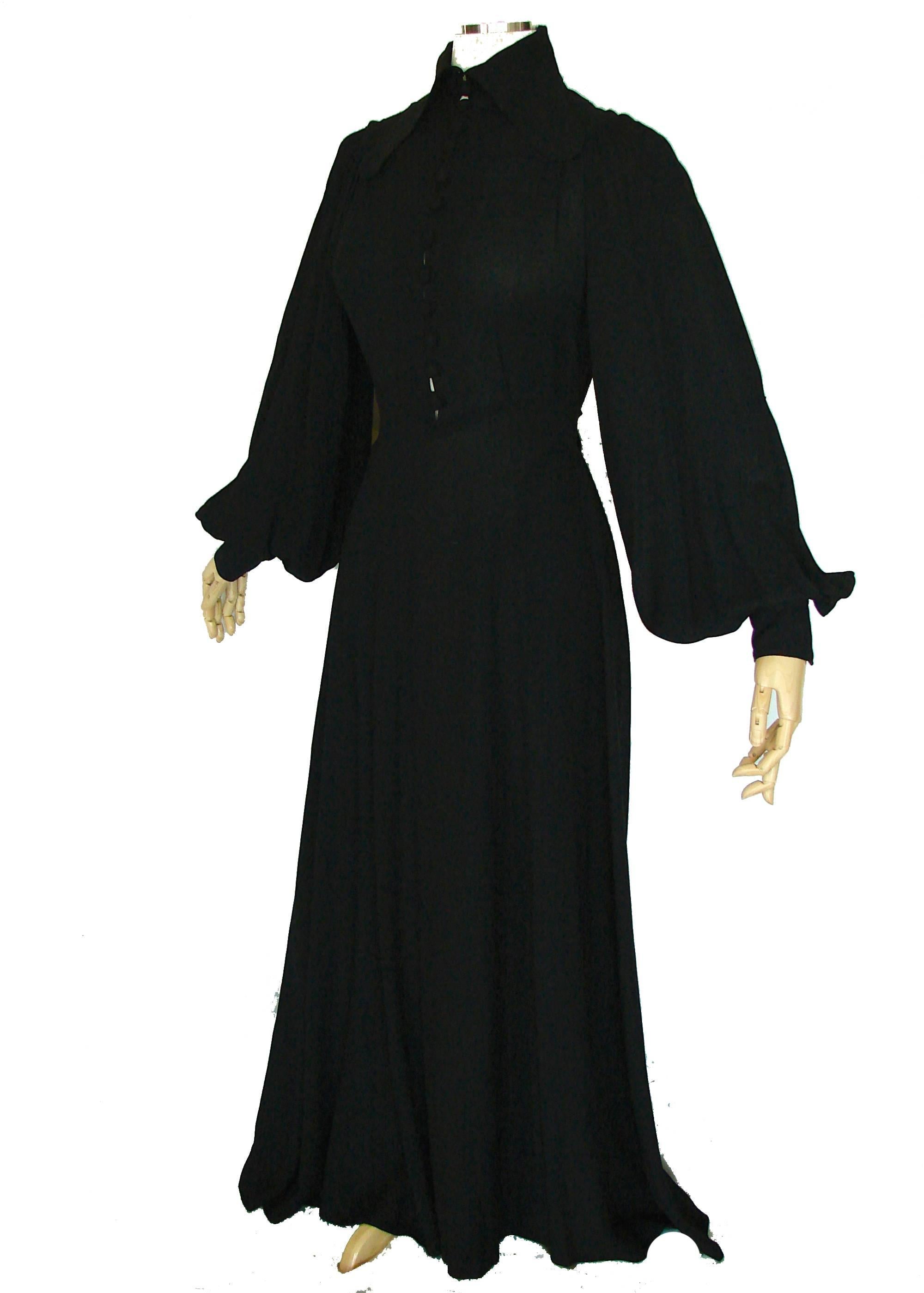 This fabulous maxi dress was designed by Ossie Clark for Radley in the 1970s.  Made from his signature moss crepe fabric in black, it features a wide lapel collar and a row of fabric covered buttons that can be adjusted to show as much or as little