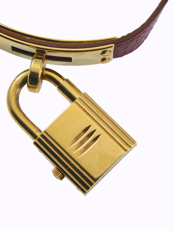 Elegant Hermes Paris Gold Kelly Watch with Red Face + Rouge H Leather Strap 90s at 1stDibs