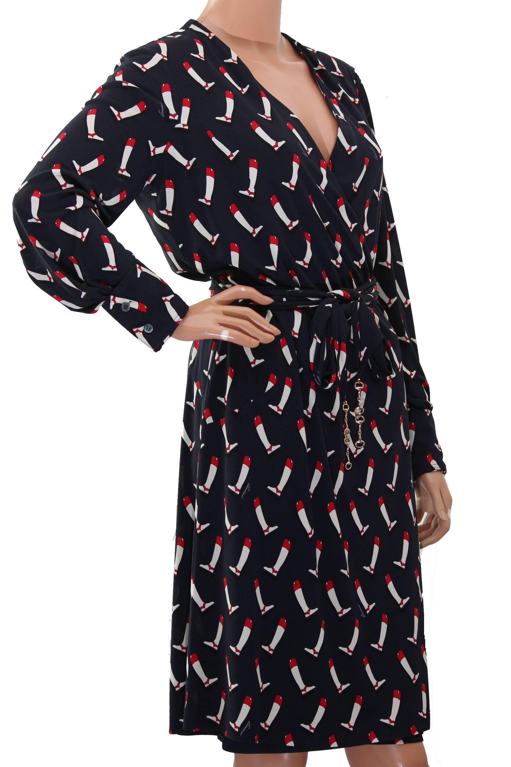 This vintage silk dress was made by Gucci and features a charming equestrian boot print on a navy background.  Wrap style, it fastens with small buttons and cinches with an attached silk belt and metal horse bit closure.  Lined in lightweight silk. 