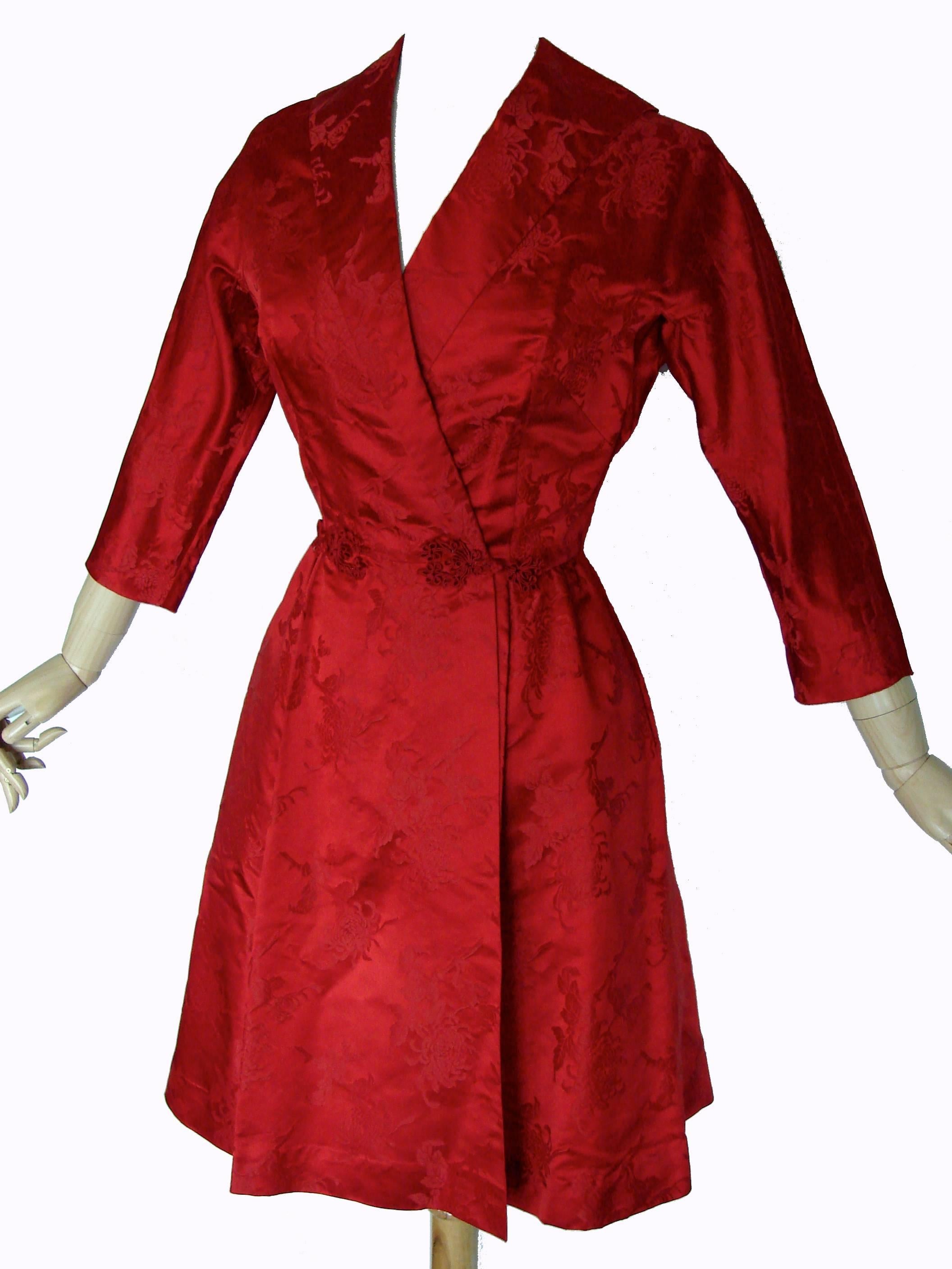 Here's a vibrant red dress from Dynasty for Lord & Taylor.  Estimated at an early 1960s production, it features Dolman sleeves, a fitted waist and flared skirt.  Fastens wrap style with silk knot buttons.  In very good condition for its age, we note