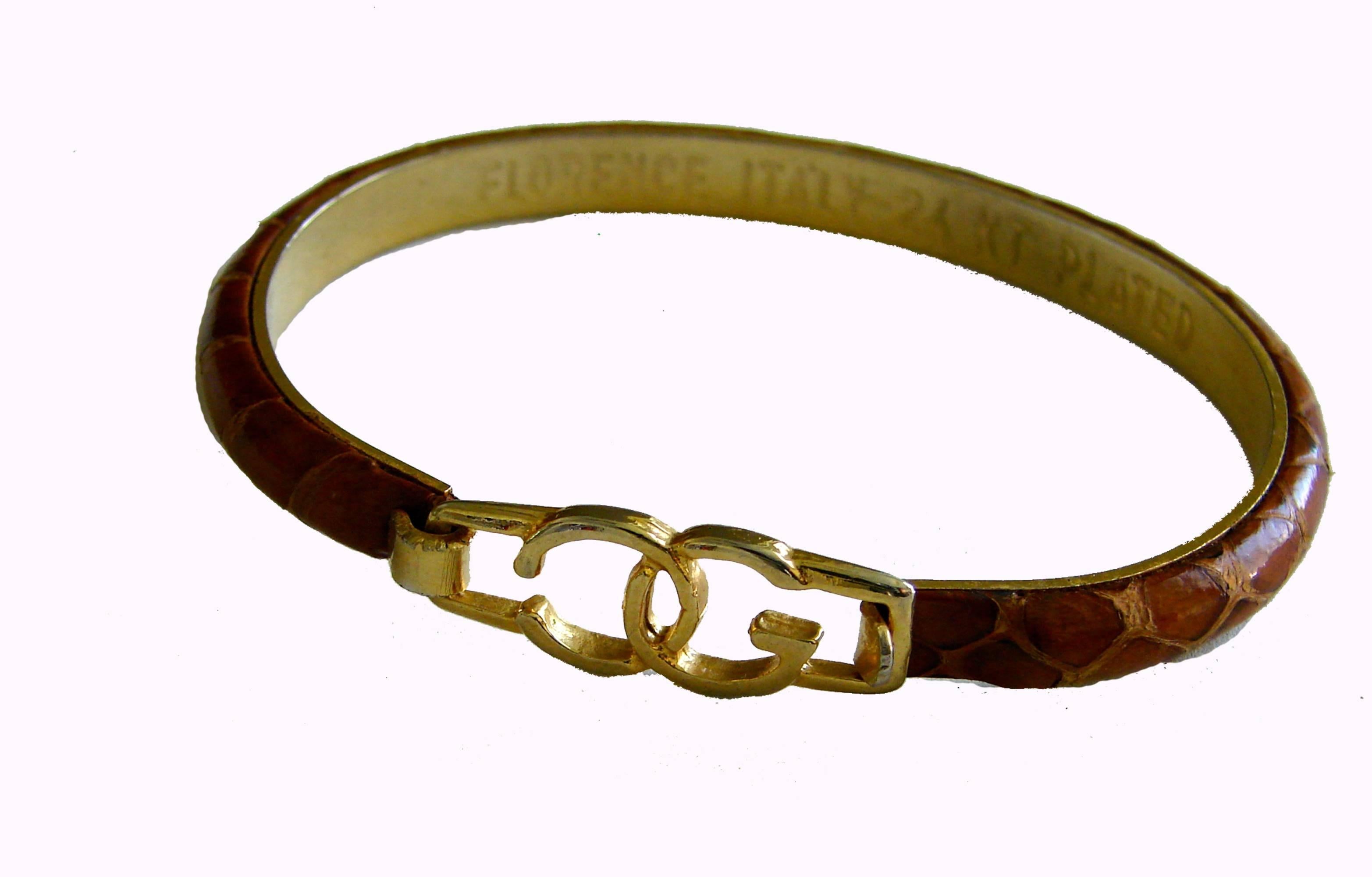 This bangle was made by Casini and Gori of Florence Italy.  From the 1970s era when fine Italian leather ware designers from Florence began making these bracelets from left over exotic skins.  Made from 24KT gold plate, it features tan crocodile