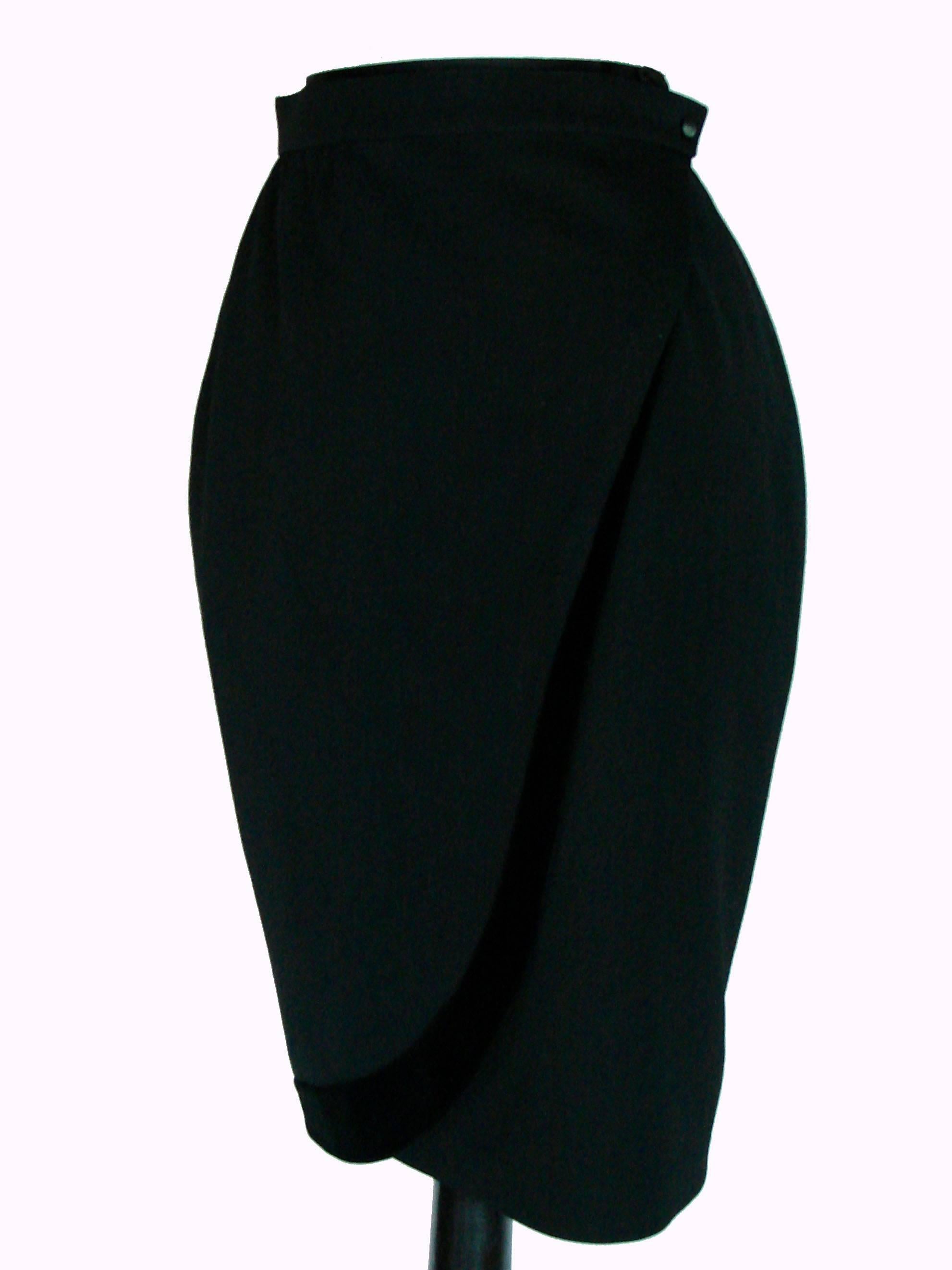 Chic black wool wrap skirt from Thierry Mugler features velvet trim and is fully lined.  This piece is new old stock, never worn and in excellent condition.  Tagged size 36, it measures taken flat and doubled where appropriate: waist - 24