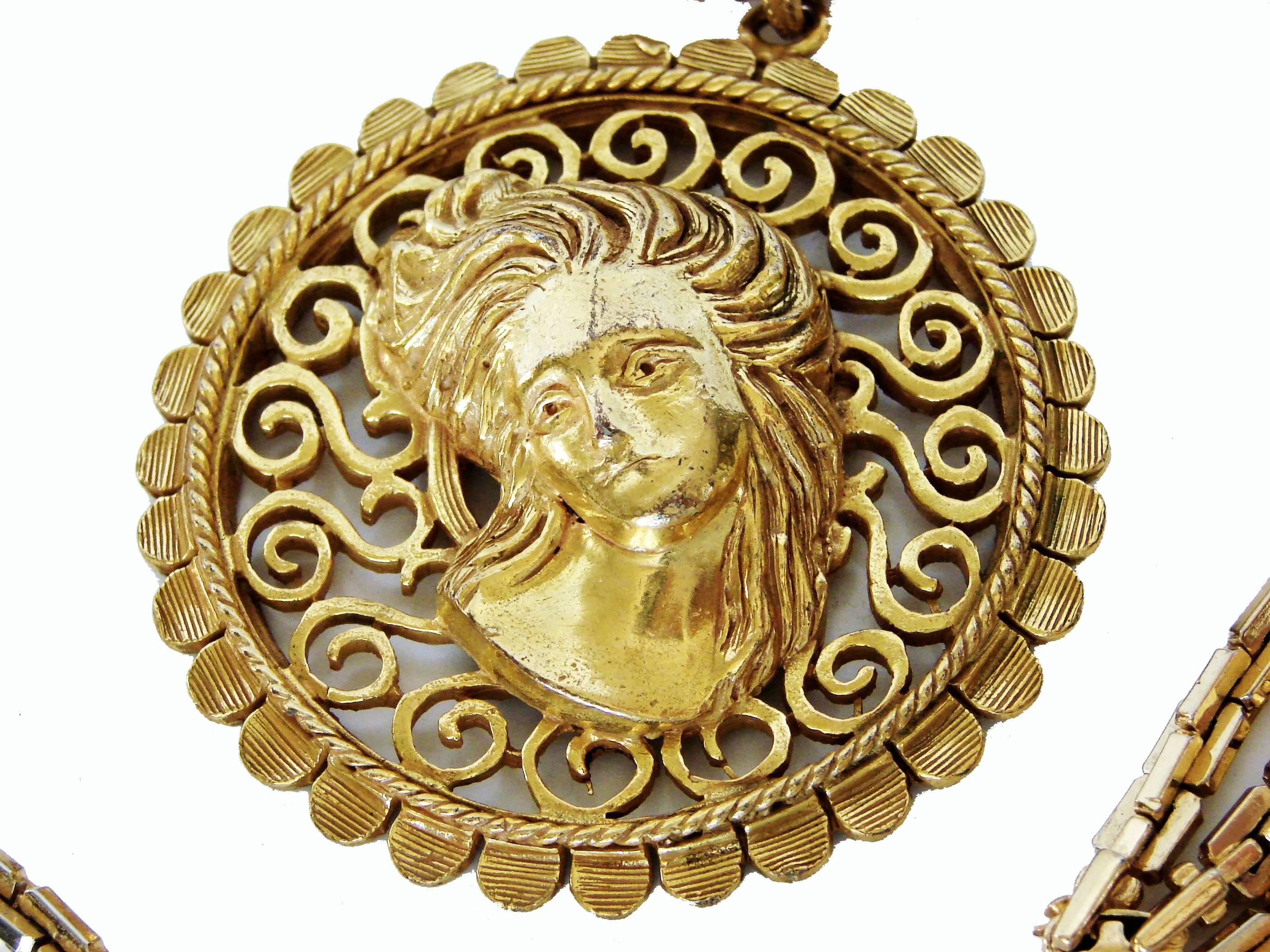 This vintage gold metal pendant was made by Lucien Piccard in the late 1970s, and features an Art Nouveau figural womans head with scrolling open work. It comes on a gold chunky link chain, which we suspect is not original to the piece.  Both pieces
