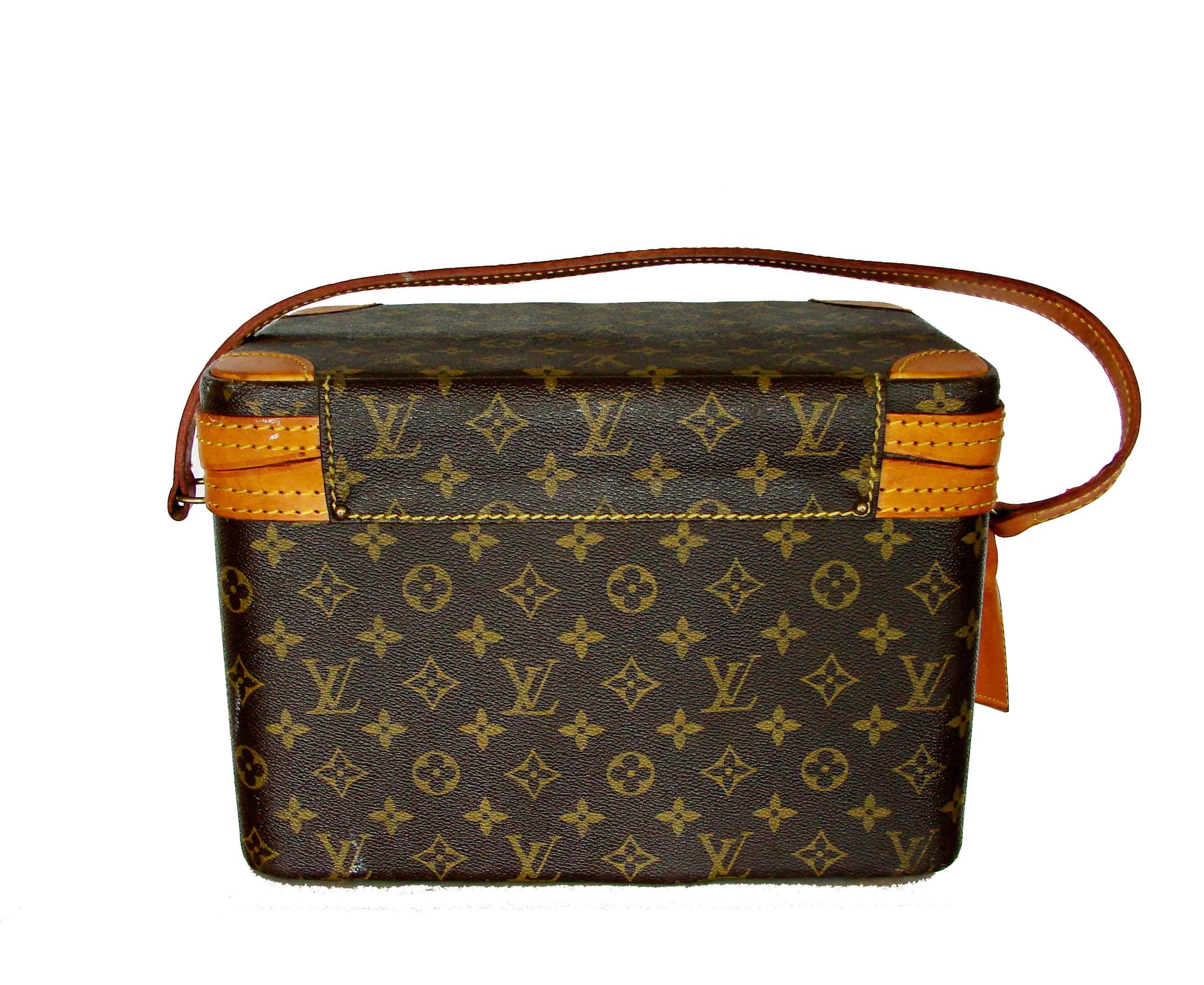 This hard to find Louis Vuitton train case or toiletries bag was made in the 1980s.  Made from their signature monogram canvas, it's trimmed in vachetta leather and the interior is lined in cloth.  The interior features a leather strap that holds up