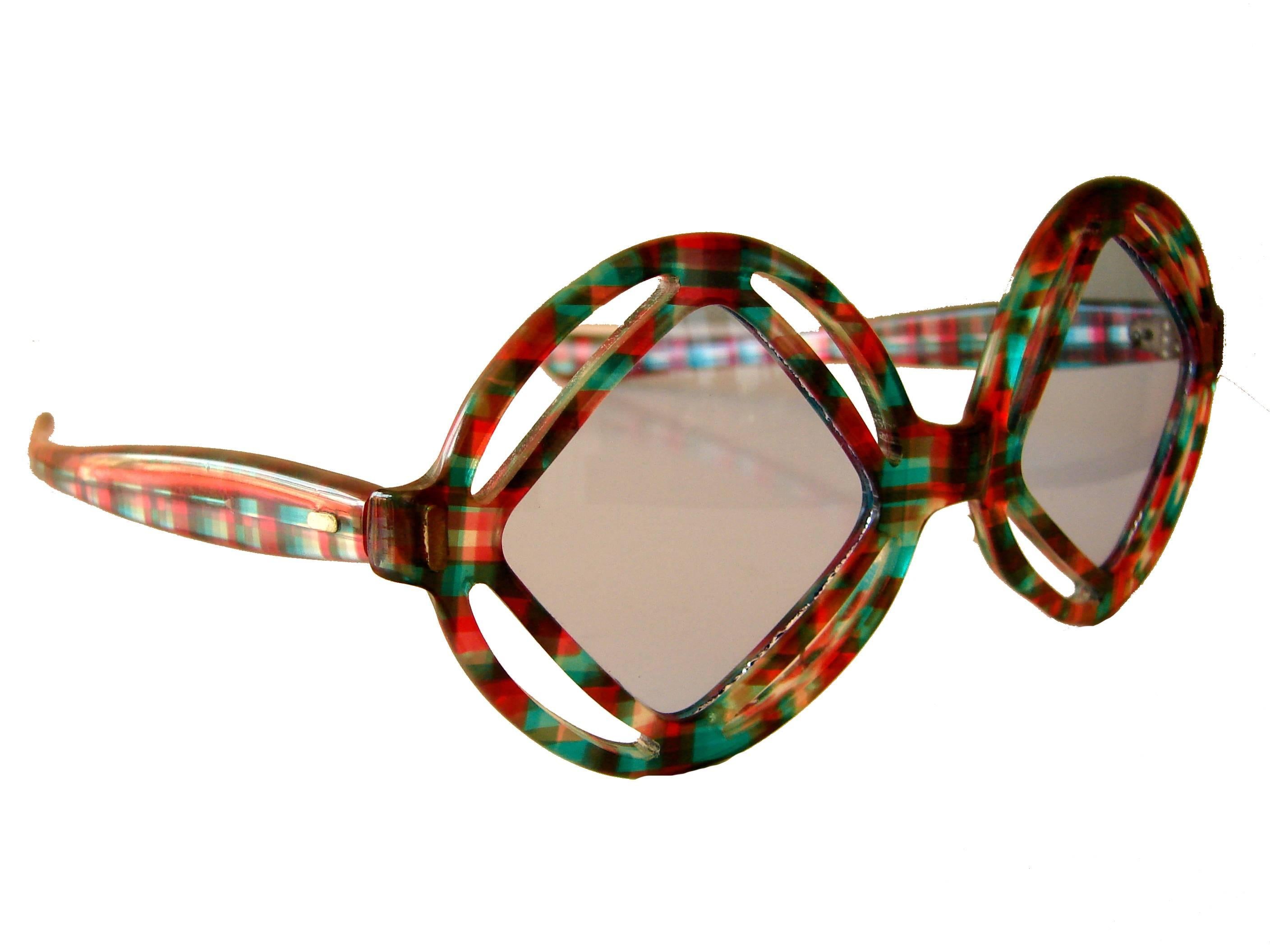 These super-chic sunglasses were made in the early 1970s by French designer Paulette Guinet.  Made from a colorful red and green plastic resin with light gray lenses.  In pristine condition.  They measure temple length: 5.5