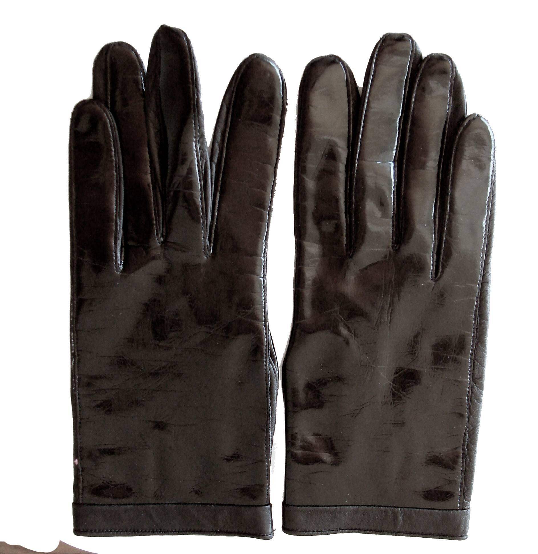 This unique set of gloves was designed by Pierre Cardin for Aris in the early 1970s.  They feature shiny black patent on one side and black calfskin leather on the other side (palm side).  Inside is lined in white cotton with the Pierre Cardin logo