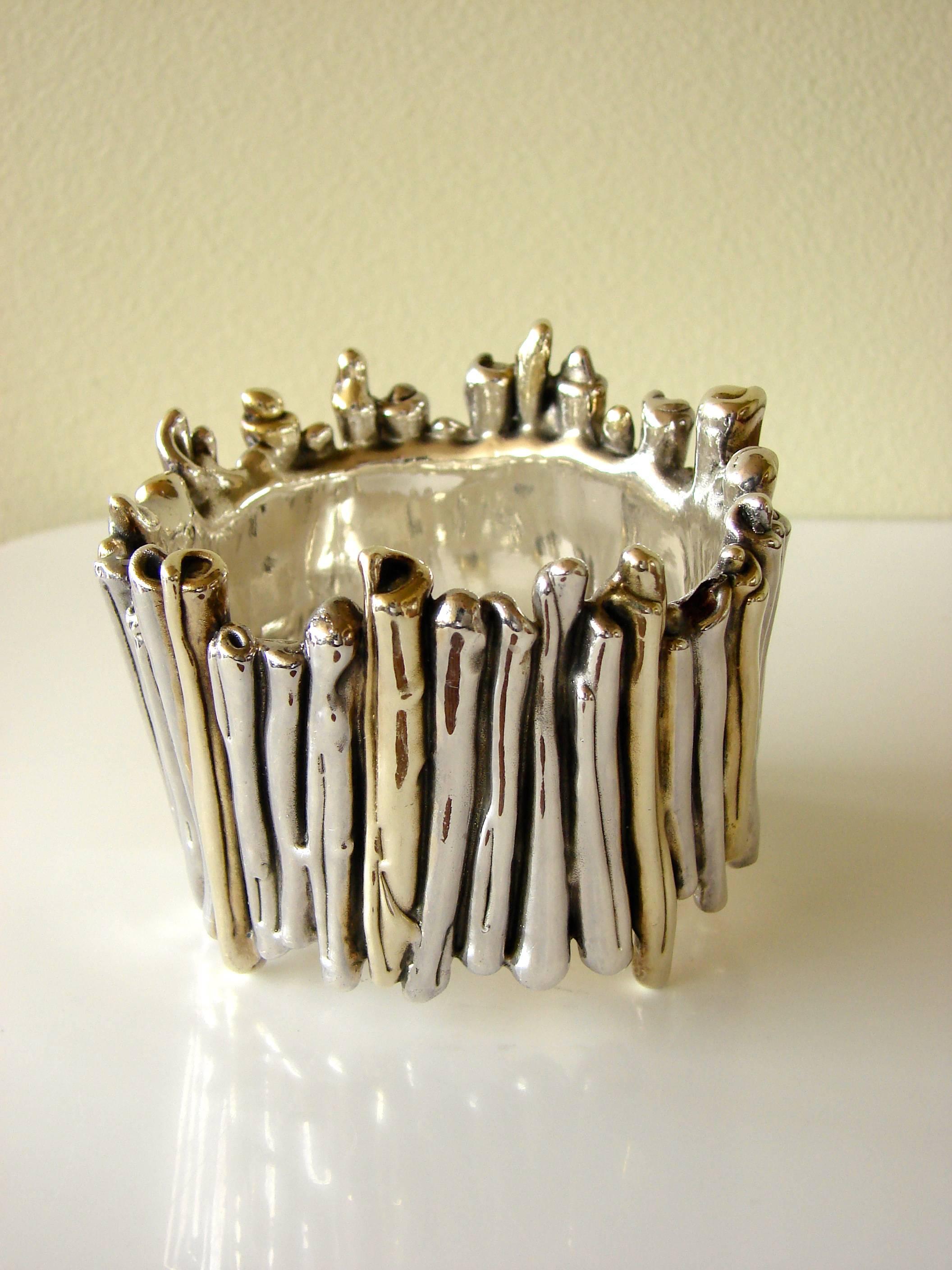 This incredible wide bracelet was designed by David Varsano of Israel in the late 1970s.  Made from sterling silver and gold metal using an electroform technique, this piece weighs approximately 95.4 grams, making it lightweight for wear.  It