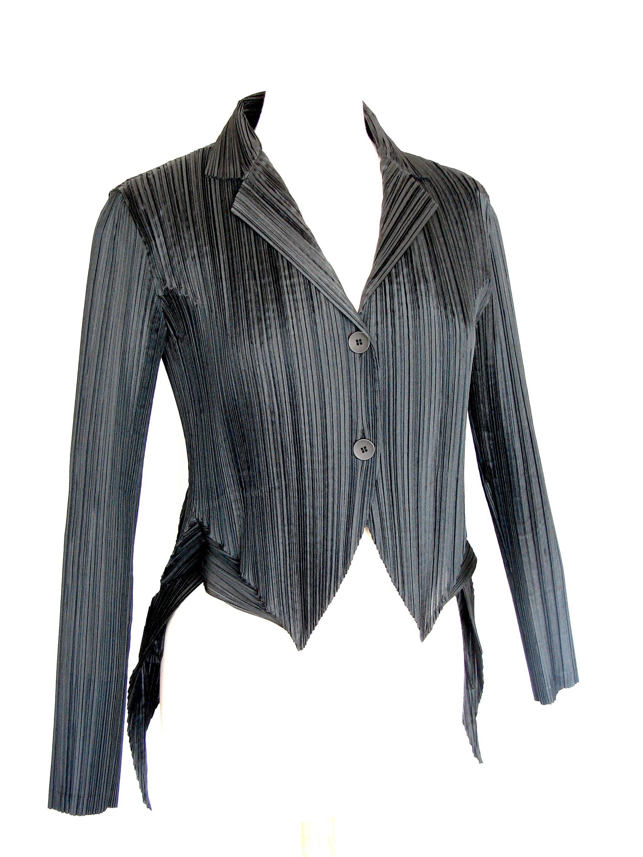 This unusual jacket was made by Issey Miyake for their FETE label in 2002.  Made from pleated polyester fabric, this piece features incredible sculptural details at the back and sides.  Unlined, it fastens in front with simple black buttons.  In