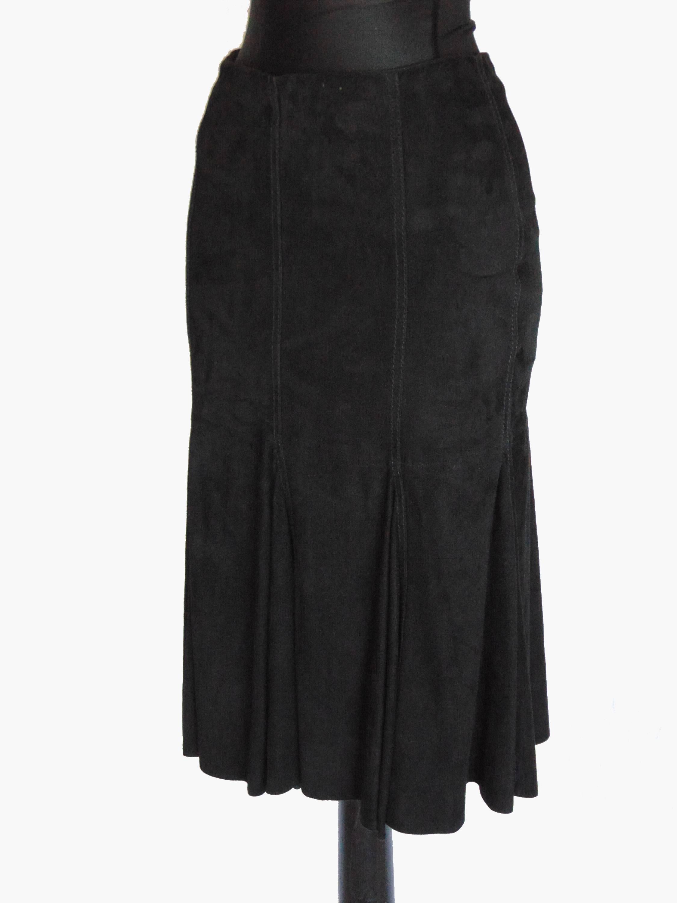 This fabulous suede leather skirt was made by Genny Italy in the 1990s.  Made from the most supple black suede leather, it's partially lined and fastens with a zipper.  The cut is designed to show off your curves and make your bottom look downright