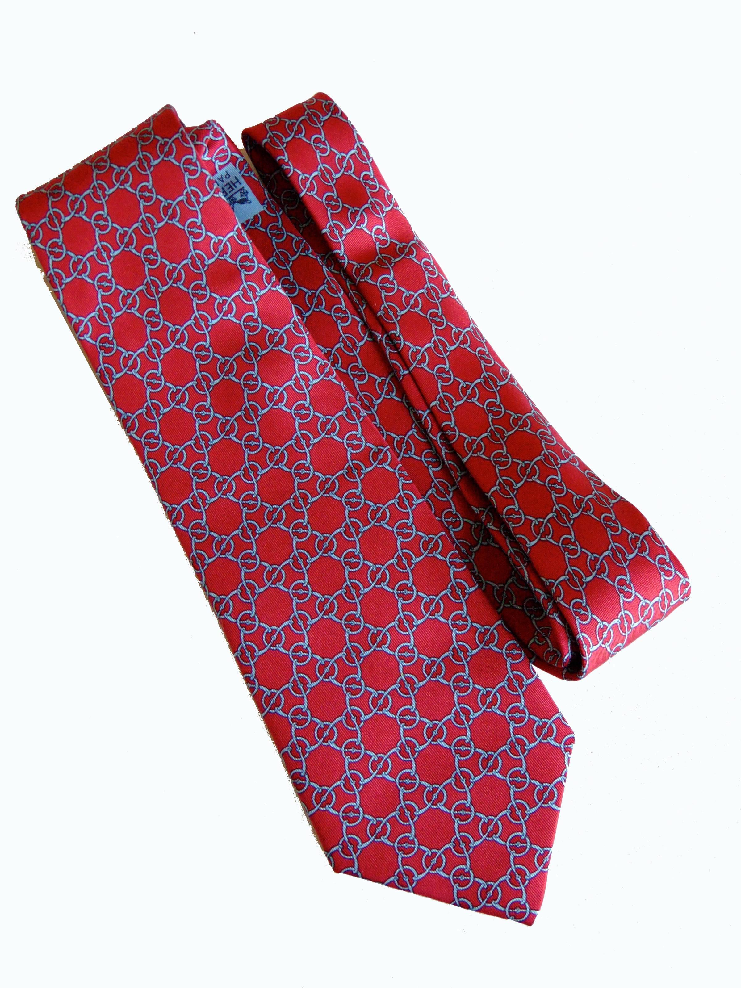 Authentic Hermes Mens Silk Necktie 7086 OA - Brick Red Snaffle Horse Bits
In excellent condition.  Measures 55