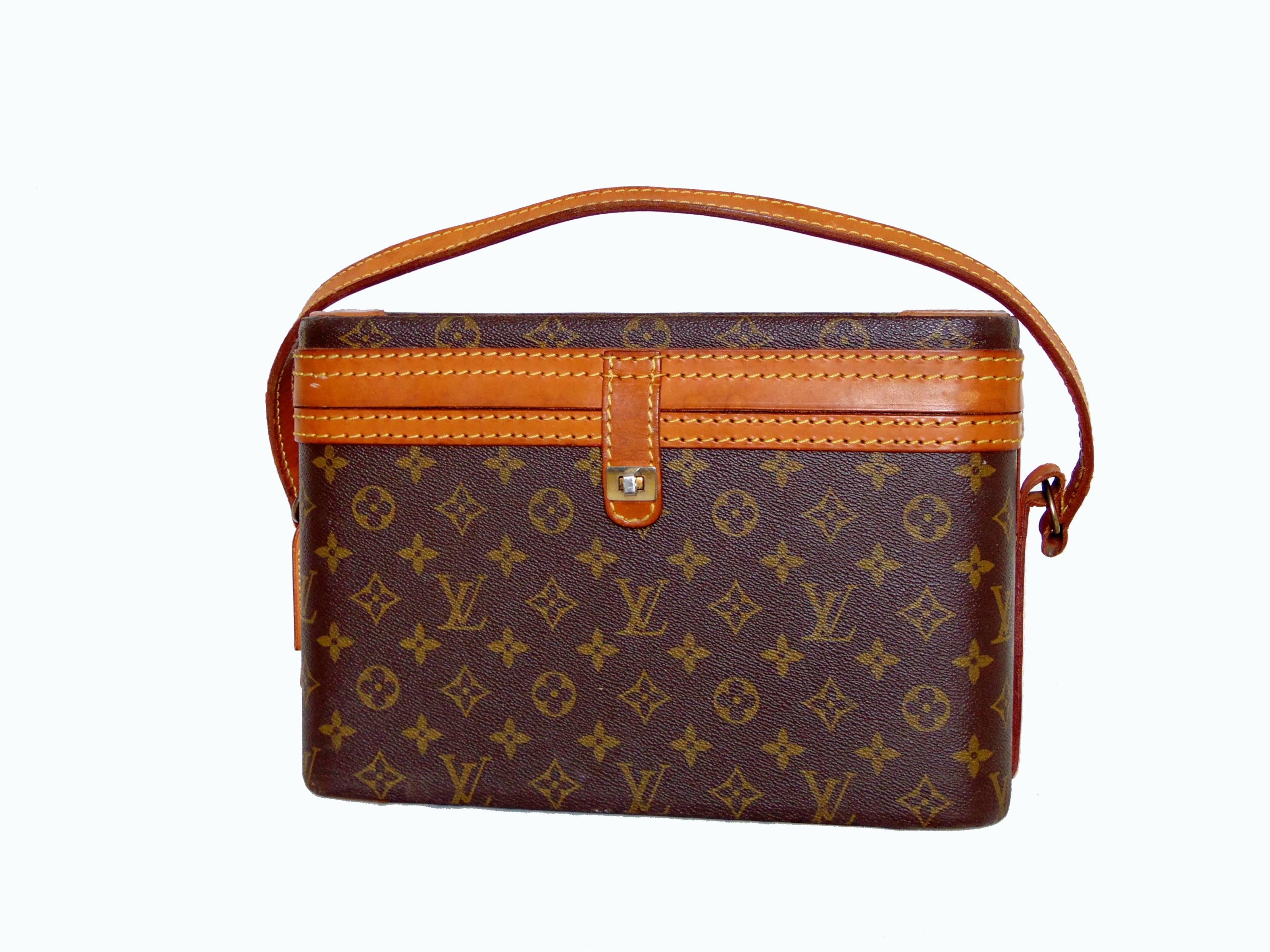 This fabulous and hard to find train case was made by Louis Vuitton in the early 1980s.  Made from their signature monogram canvas, it's trimmed in vachetta leather and fastens with a gold metal turn lock.  The interior is lined in cream fabric and