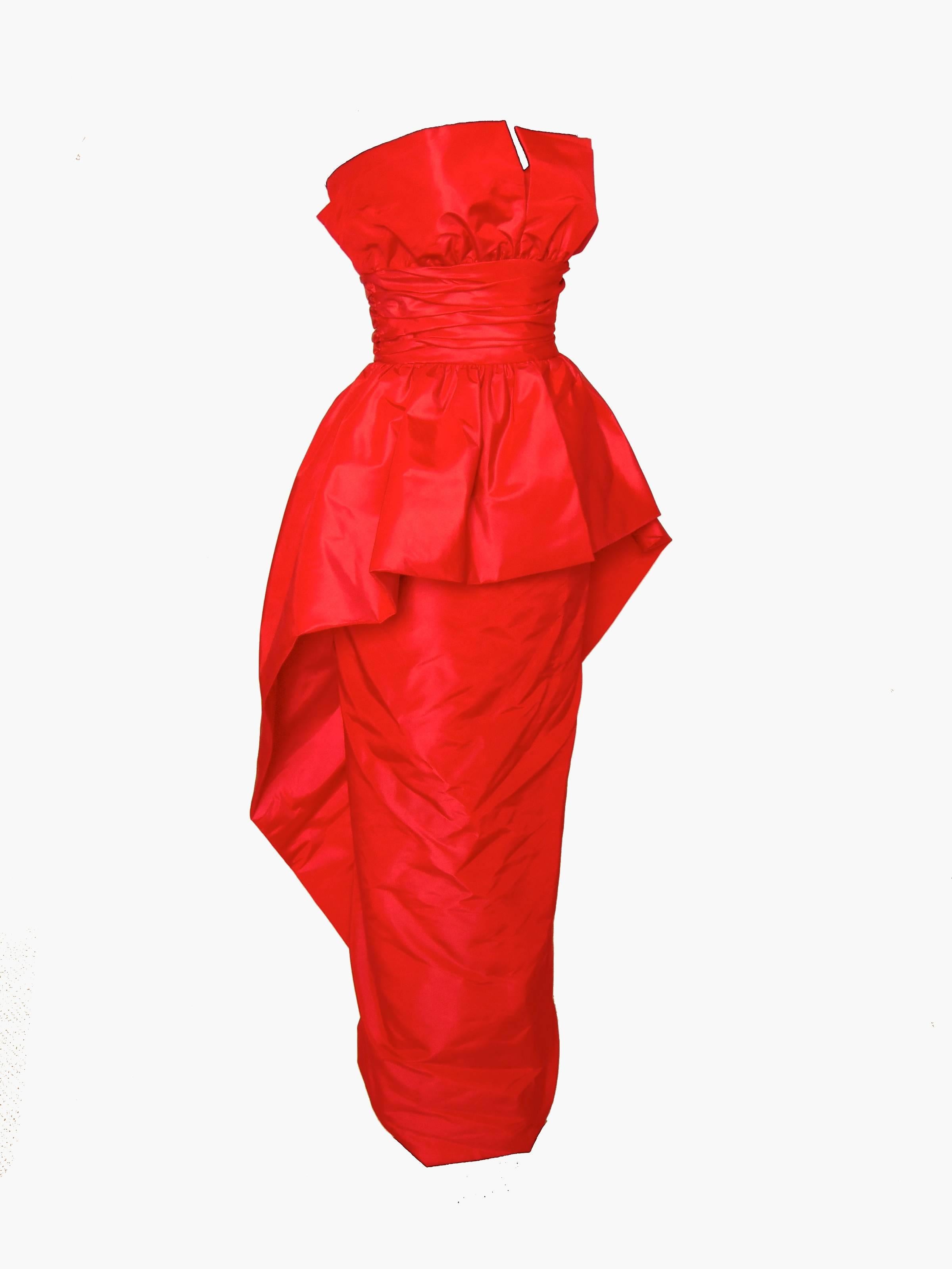 This brilliant evening gown was designed by Victor Costa in the late 1970s.  Made from a polyester/nylon blend taffeta, it features a sheath skirt with an overlay to add dramatic volume.  In excellent condition.  Tagged Victor Costa, there's no size