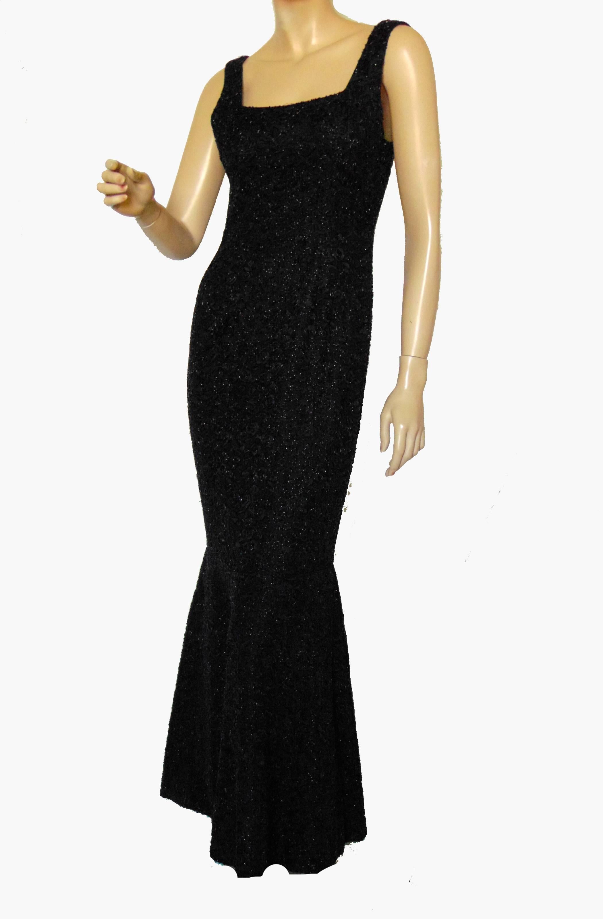 This fabulous evening gown was likely made in the 1960s and is made from a substantial floral brocade fabric with tons of black bugle beads throughout.  The mermaid silhouette is so chic, and the weight of the fabric is perfect for movement through