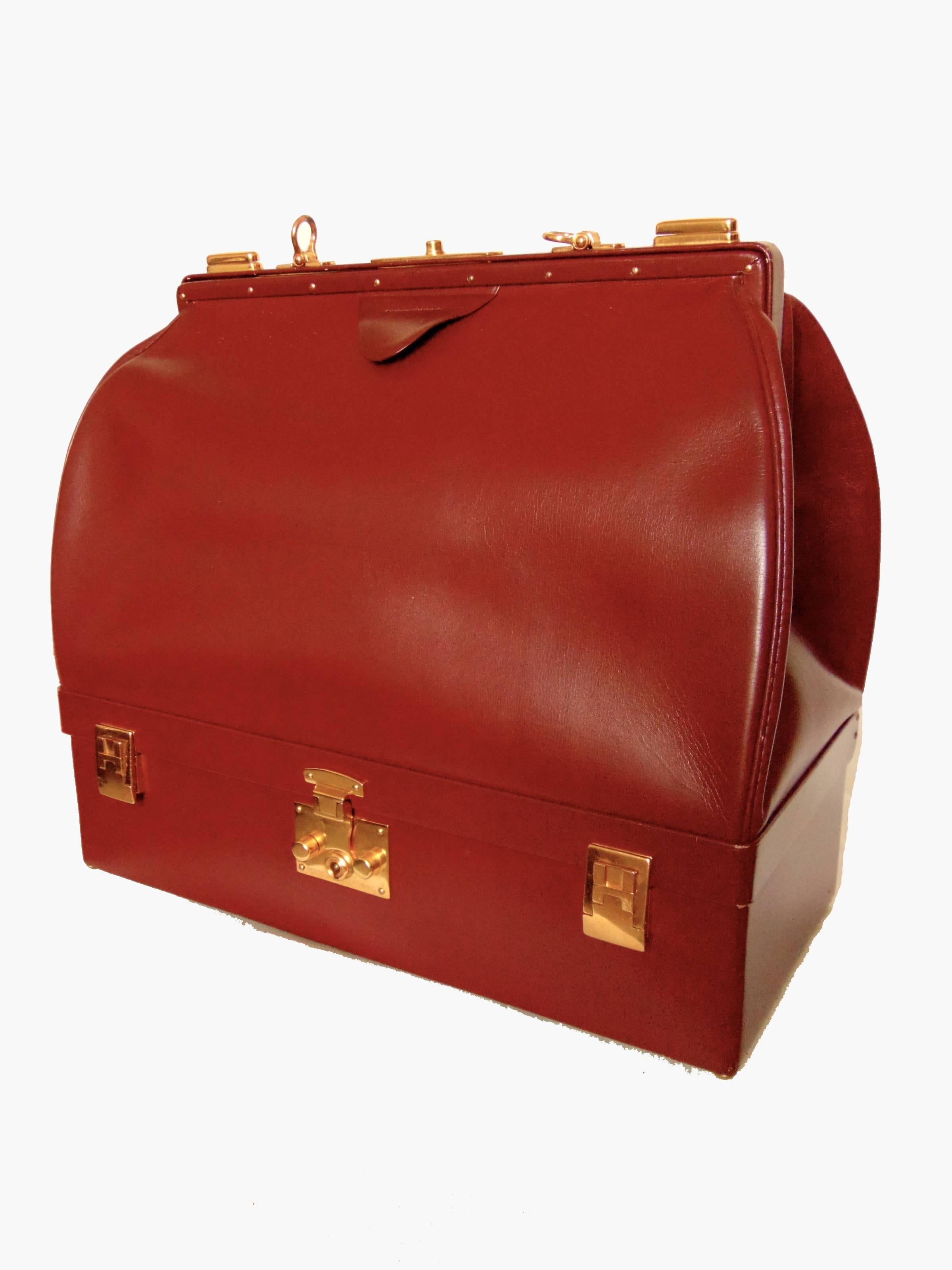 This rare Sac Mallette bag or travel case was made by Hermes, most likely in the 1970s.  Made from their classic box leather in a rich shade of cordovan, this piece features two compartments: the top section, which is tall and lined in goat skin for