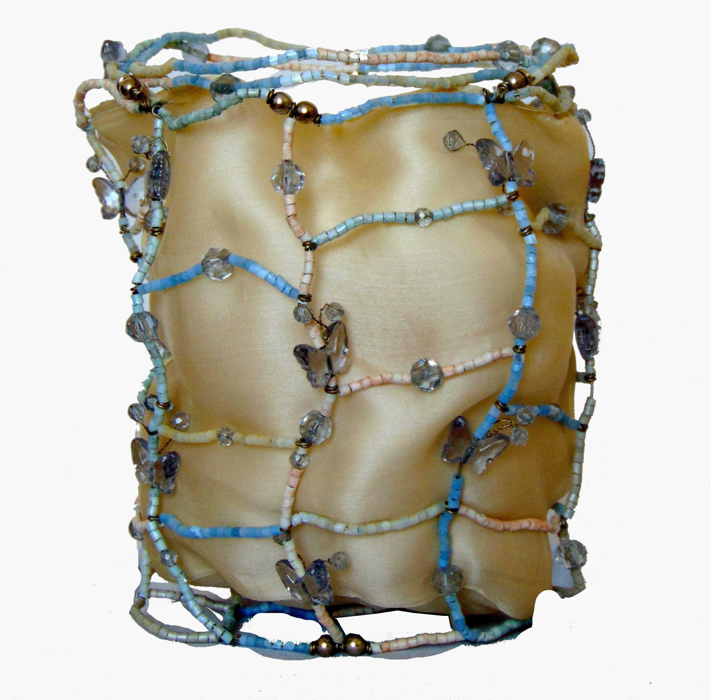 Hard to find bag from Bottega Veneta.  Made with a wire frame covered in pale powder blue and white beads, it features gemstones and tiny butterflies throughout.  Fully lined in cram silk, it has two dainty wrap ties at top.  Stamped Bottega Veneta