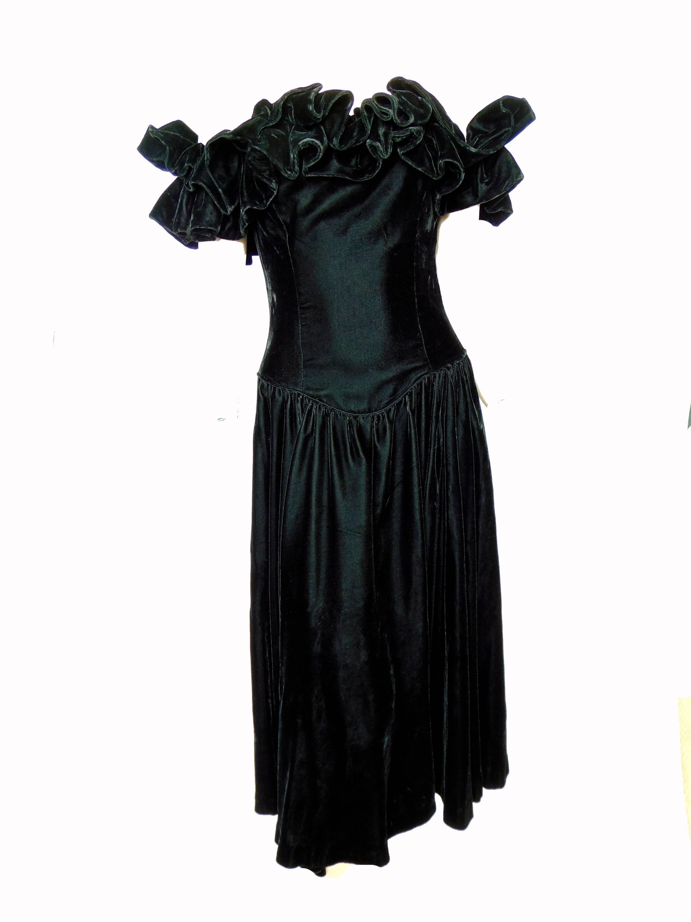 This fabulous cocktail dress was designed by sisters Christina and Jan Barboglio, most likely in the 1980s.  Jan eventually moved on from clothing design and now creates furniture and home accessories for her eponymous label.  

Made from black