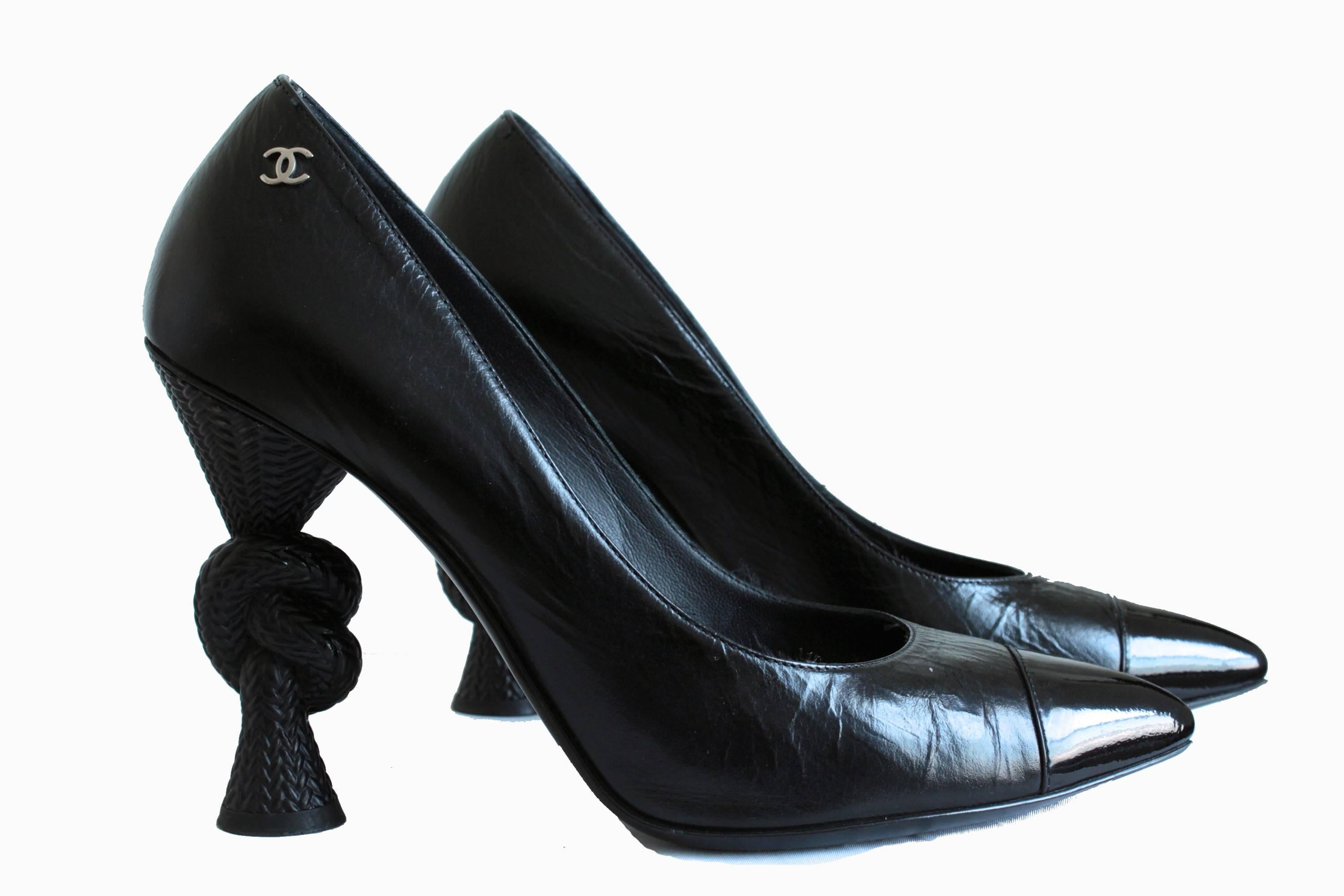 Released as part of the 2014 Resort collection and now impossible to find, this pair of knot heels are made from black leather with patent toe caps.  In very good condition overall, we note some dings to the black resin on the knot heels, and wear