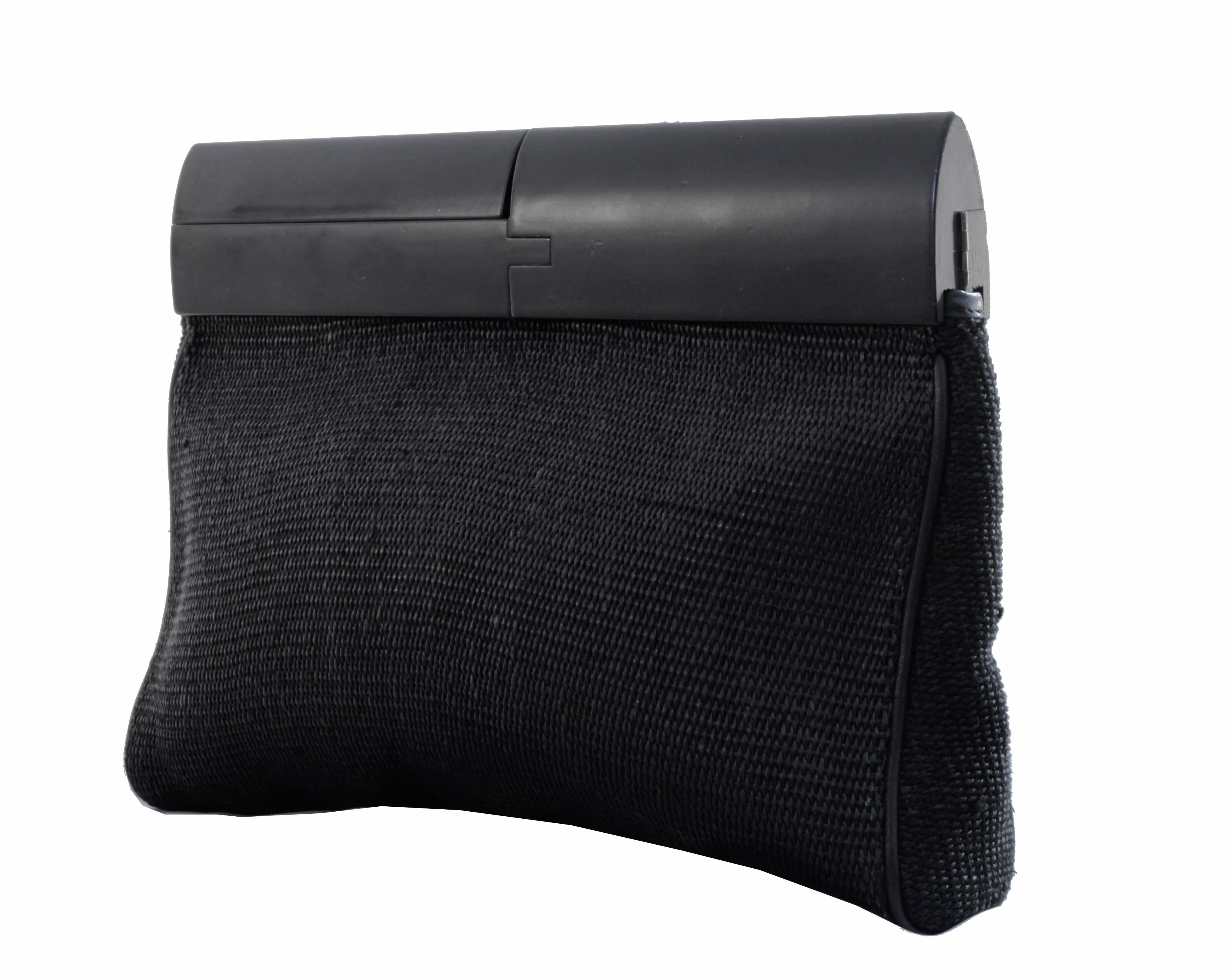 This fabulous black woven clutch was manufactured by De Vecchi of Italy and designed by Hamilton Hodge, who did stints for Bottega Veneta, Donna Karan and Ferragamo, most likely in the early 1990s.  Made from what we believe is a silk/cotton blend