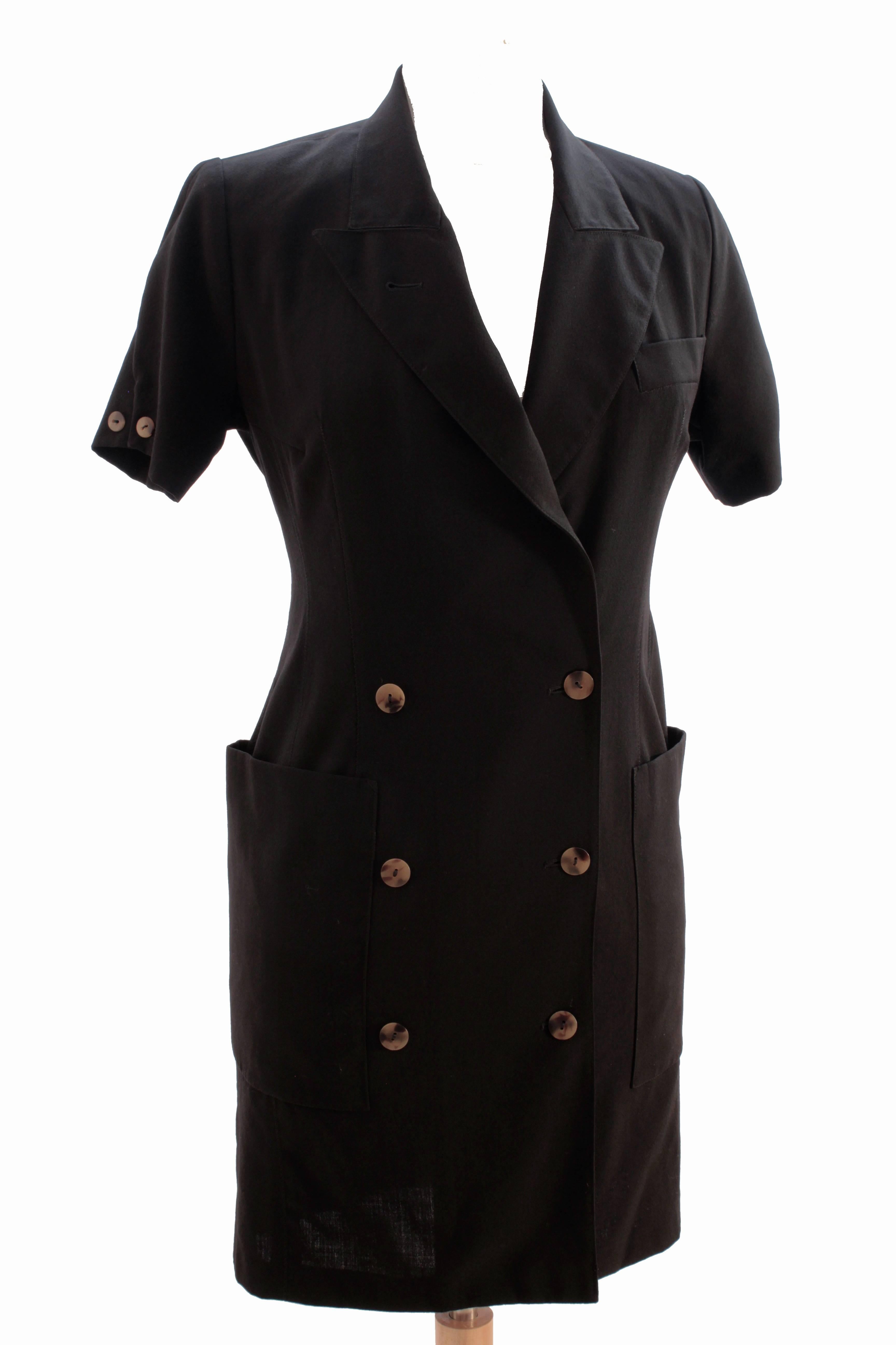 Here's a chic little black dress from Jean Paul Gaultier Pour Gibo, likely made in the 1990s.  Made from what we believe is a viscose wool blend (no content label), it features double breasted construction with oversized pockets at each hip. 