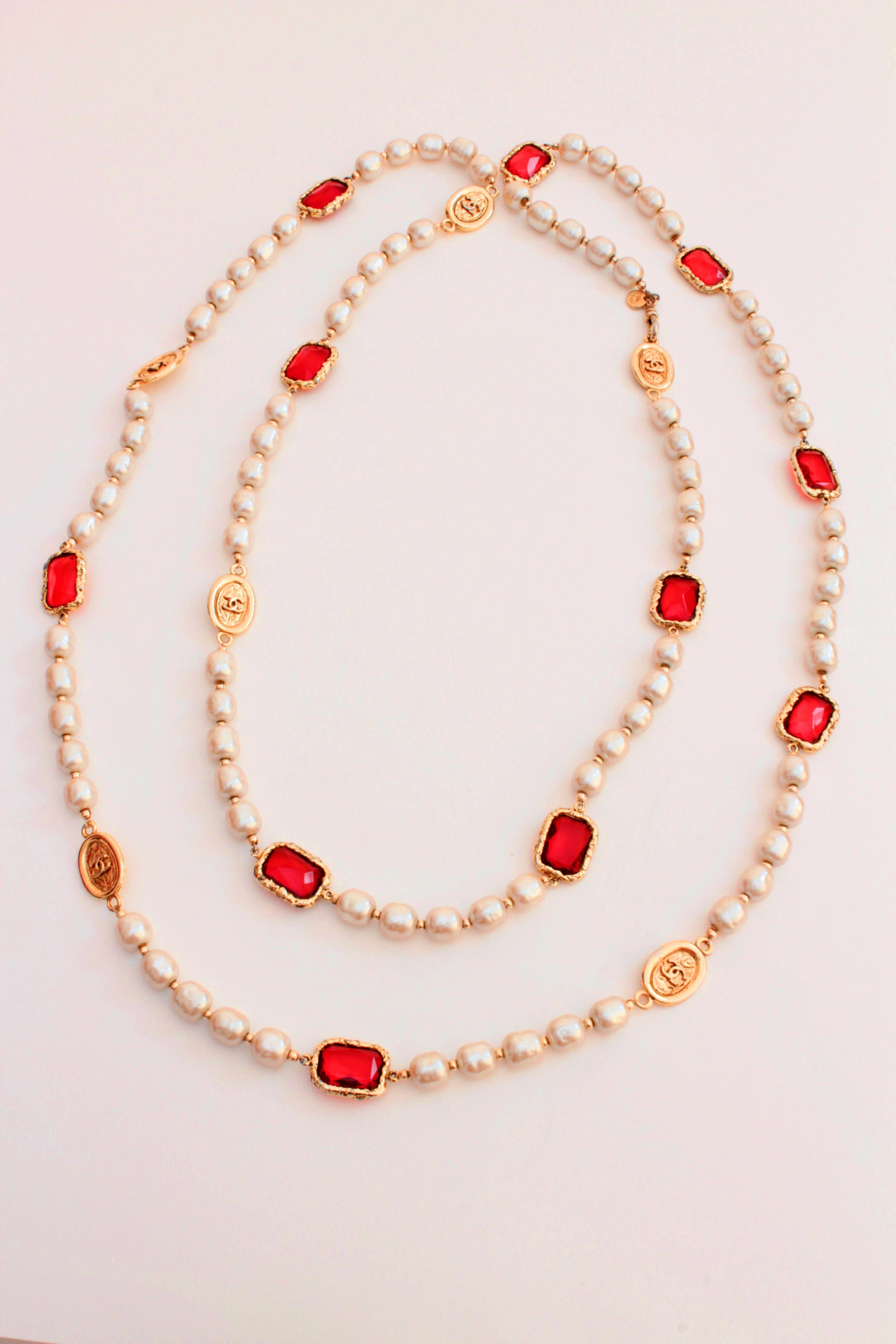 This fabulous long necklace was made by Chanel in 1981, and features faux pearls, red Gripoix or poured glass chicklet jewels and gold metal medallions.  It measures a total length of 60in, making it perfect for doubling or draping, opera-style.  In