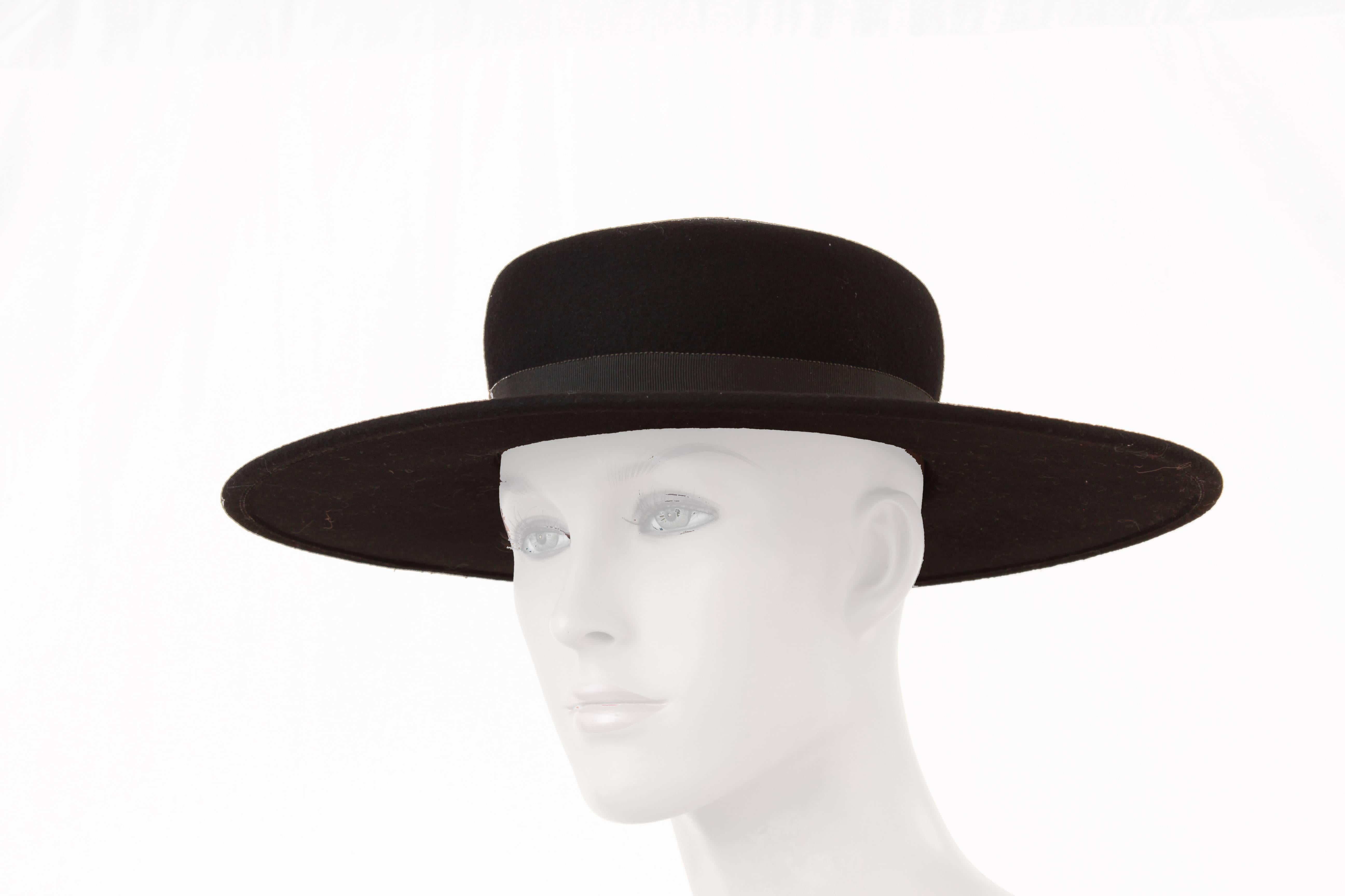 This wide brim hat was made by Bollman Hat Company for Yves Saint Laurent, most likely in the early 1970s.  Bollman Hat Co, the oldest hat company in the USA, has been creating quality hats since 1878 and is known for creating specialty pieces for