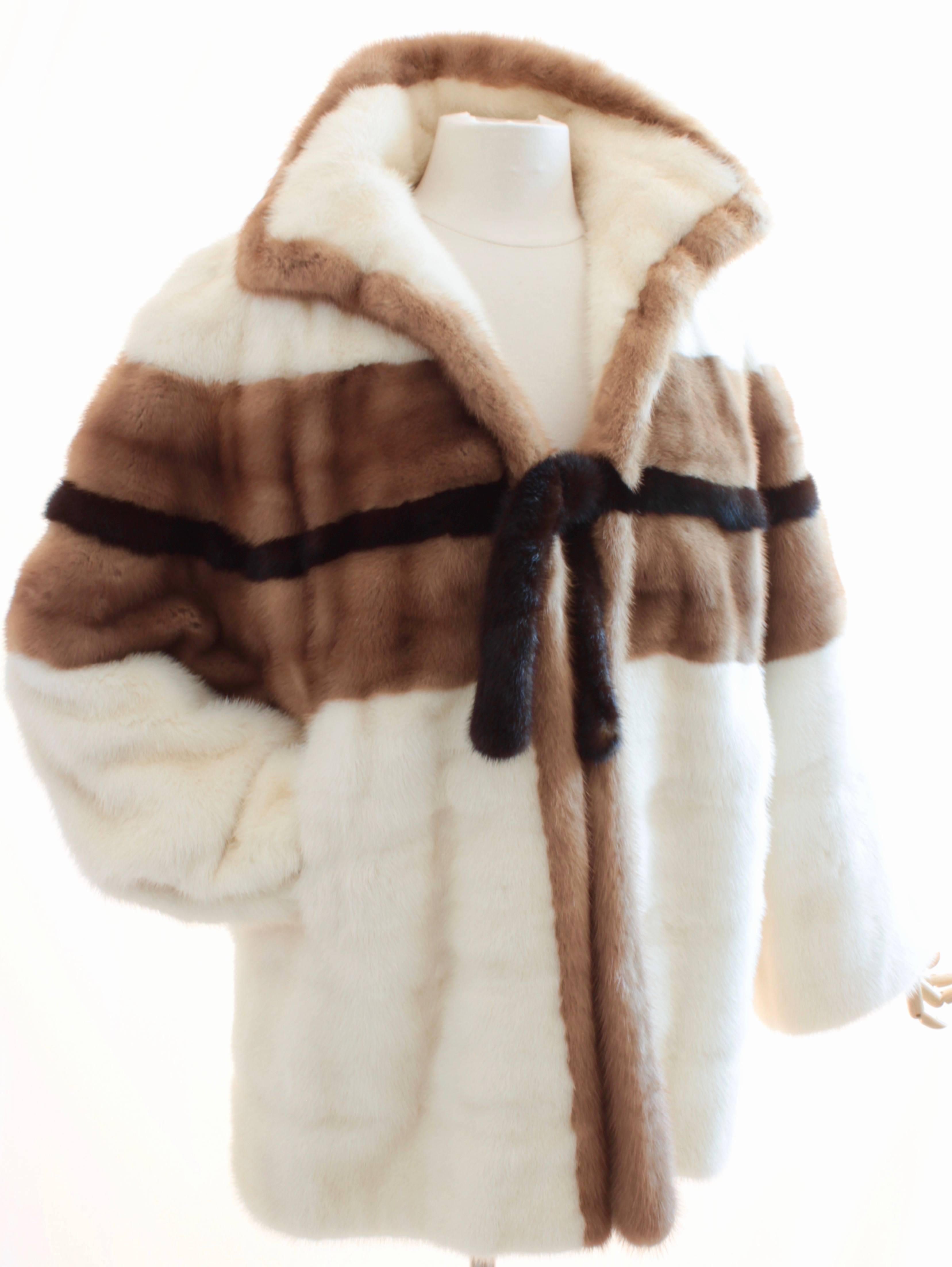 This gorgeous jacket was made by Grosvenor Canada exclusively for Bonwit Teller, most likely in the late 70s.  Made from genuine mink in white, pastel and ranch, it features a wide lapel (perfect for standing up), slightly belled sleeves, fur wrap