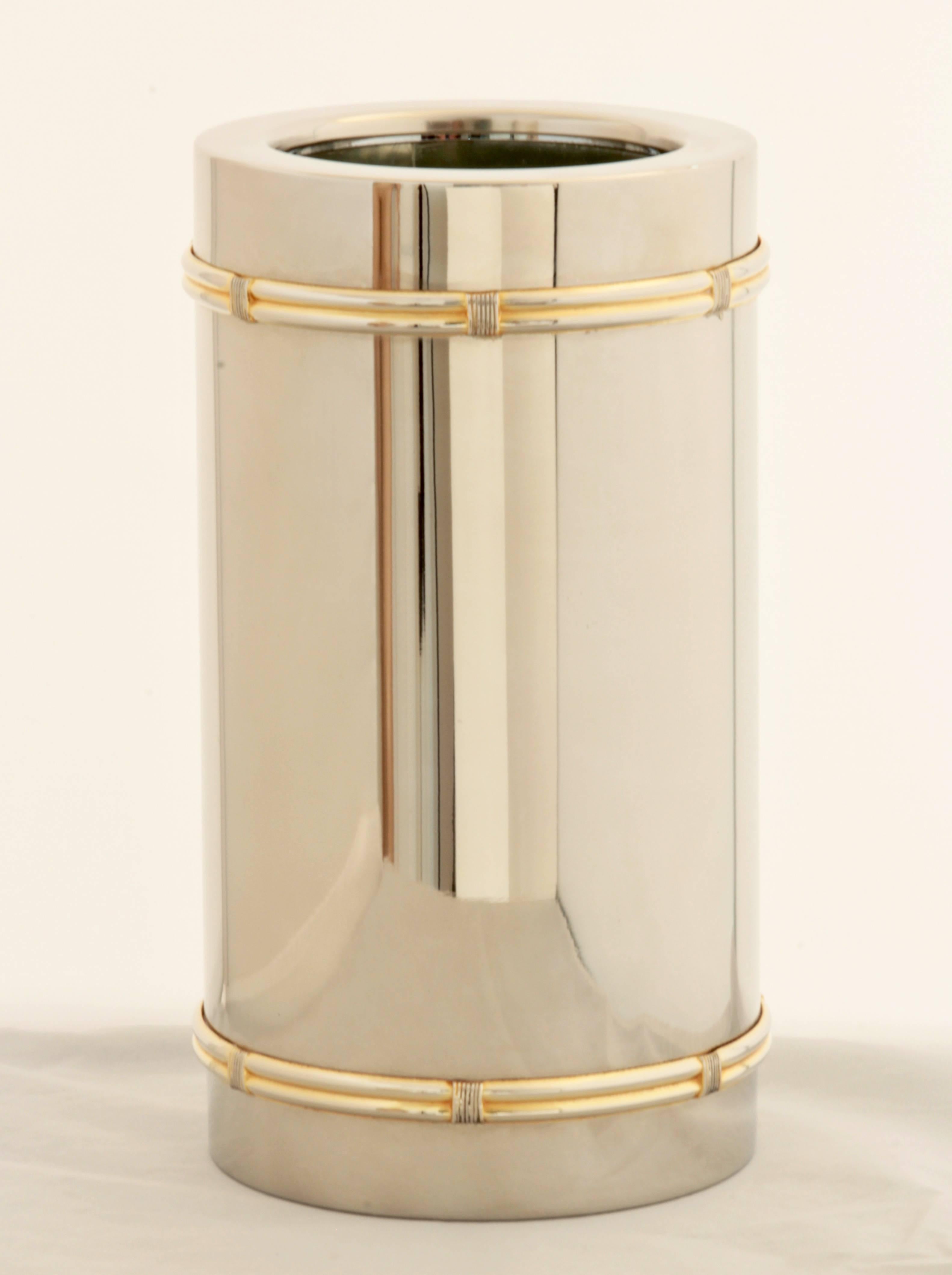 This fabulous bottle cooler was made by Gucci, most likely in the late 70s.  Made from silver plate, it features gold rope detailing and an interlocking G logo.  Insulated to keep your favorite bottle icy cold.  Measurements: 9in L x 5in Diameter