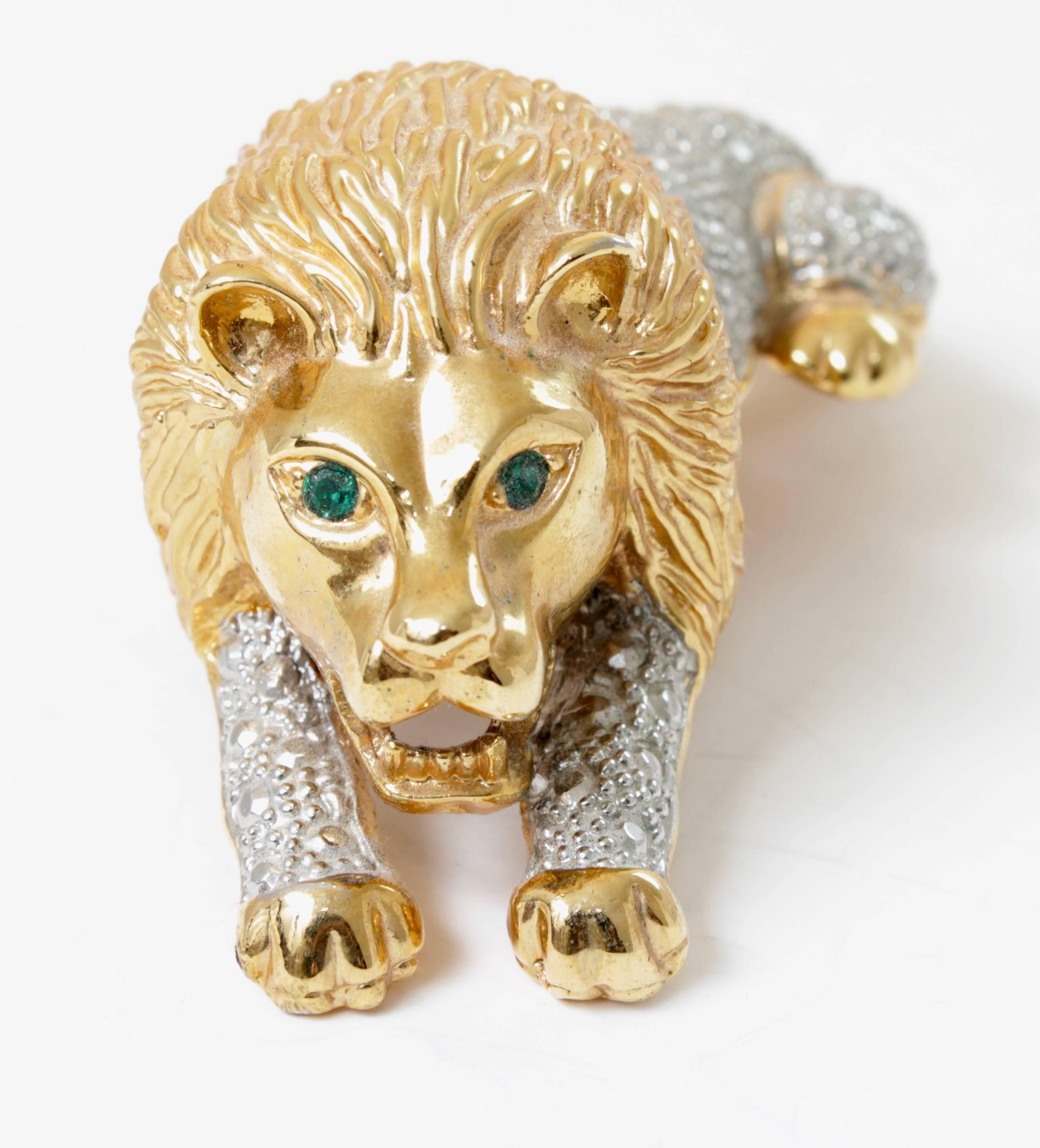 This roaring lion brooch or shoulder pin measures 4.2 in long and features striking emerald green cabochon eyes, very much in the style of Hattie Carnegie.  It measures 4.2in L by 2in W and is unsigned.  In very good vintage condition, we note some