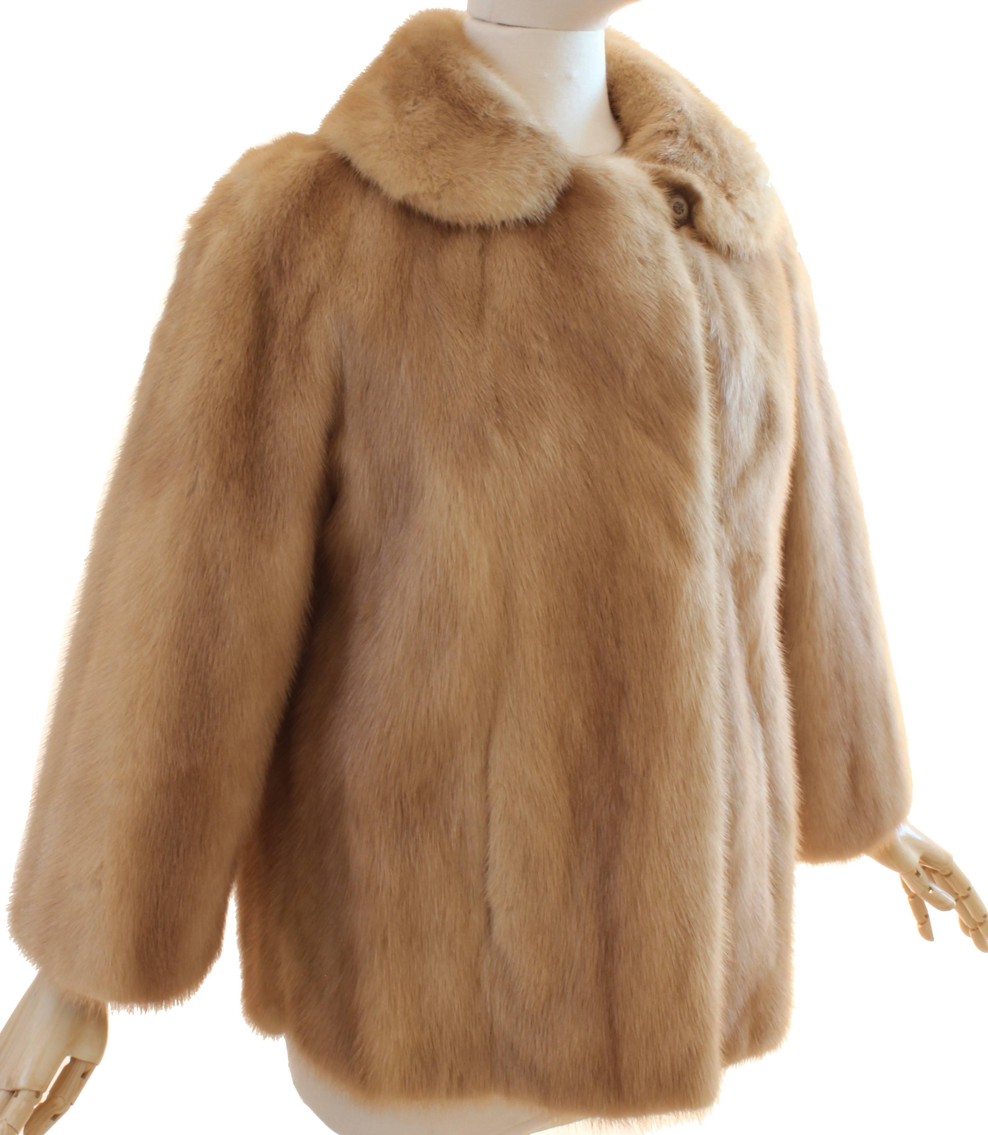 Here's a blonde mink jacket from Flemington Furs NJ, most likely made in the late 1960s. This piece fastens with a button and loop at the neck and two hidden hooks at the chest and waist and features hidden pockets at the sides.  Fully-lined with