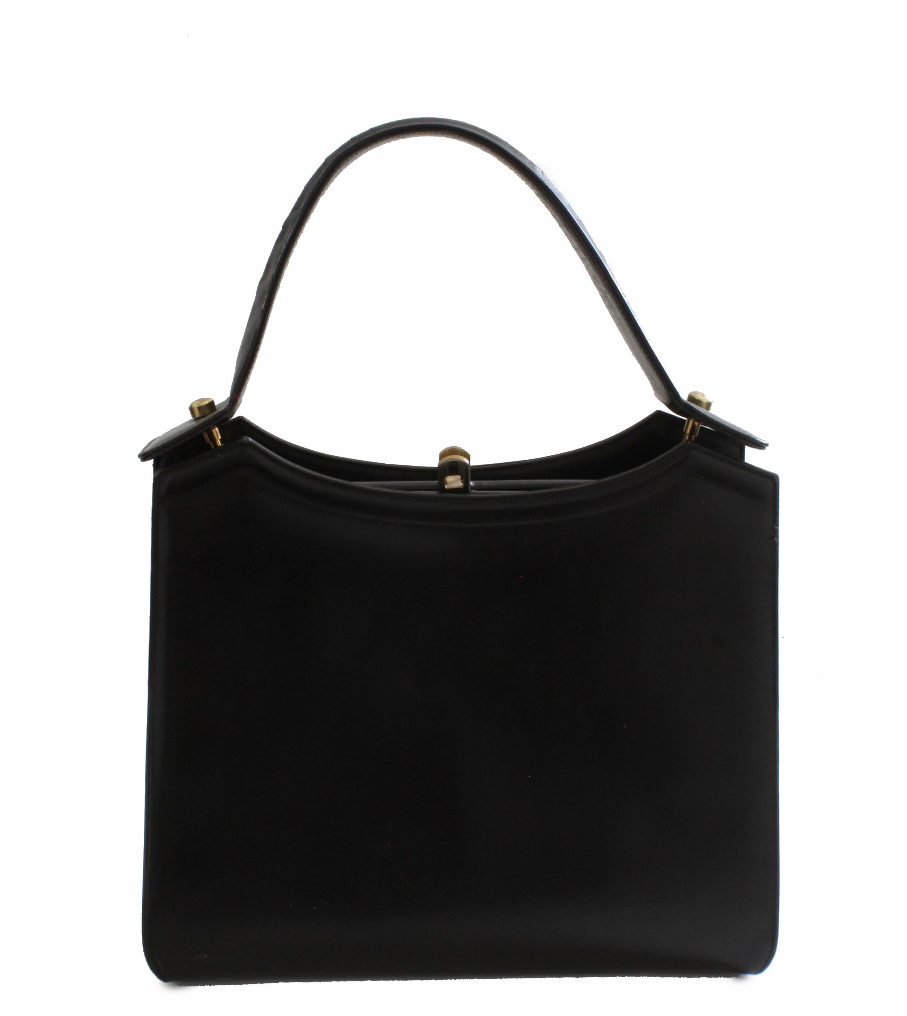Here's a fabulous black leather bag from Coblentz, most likely made in the early 1960s.  Made from black box leather, this structured bag features brass hardware and a hinged main compartment that's lined in grosgrain fabric with one flat zip pocket