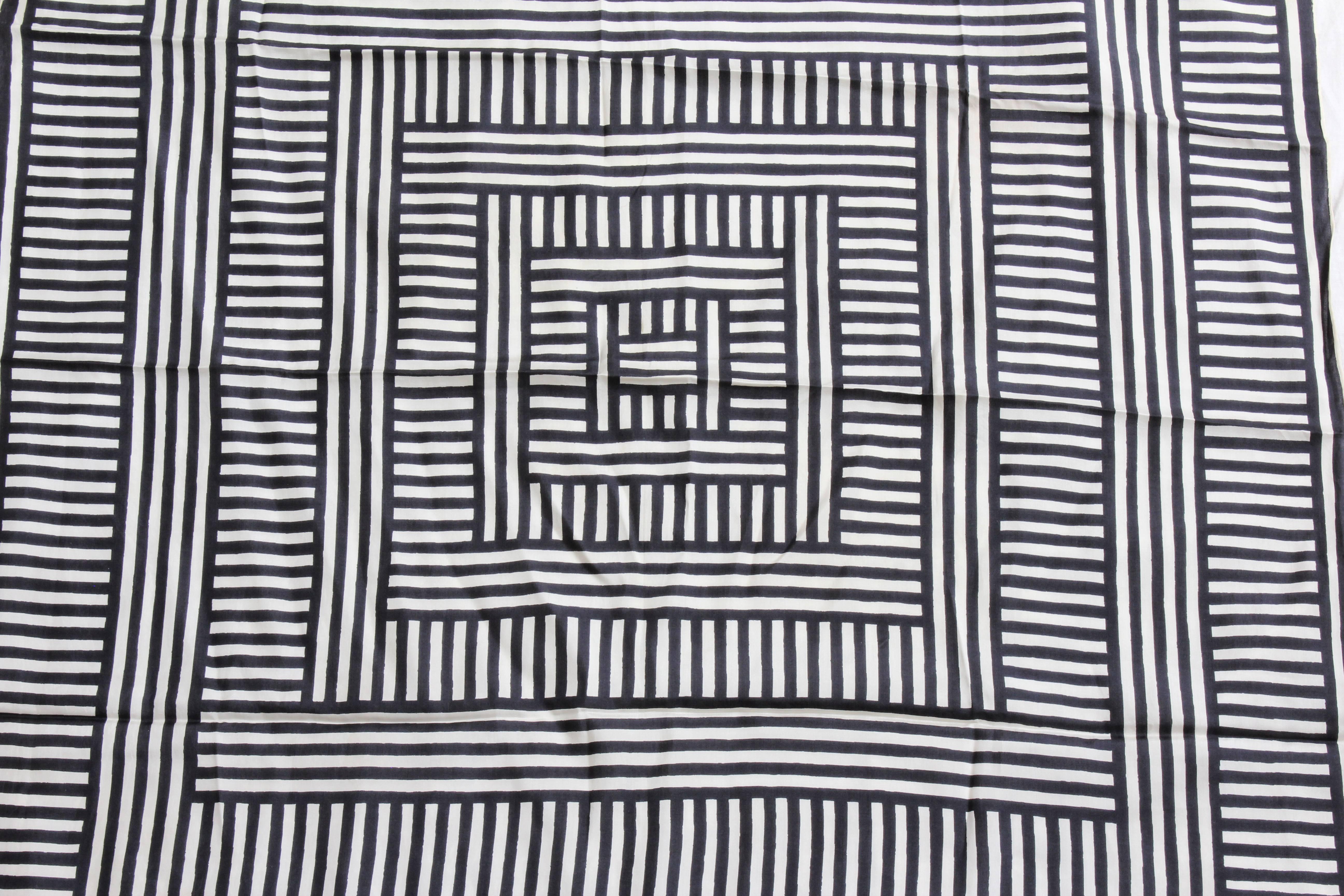This unusual op art scarf or shawl was made by VERA, aka Vera Neumann, most likely in the late 1970s.  Made from silk, it features a black and white optical design and is signed by Vera with her signature lady bug logo.  It measures appx 31in