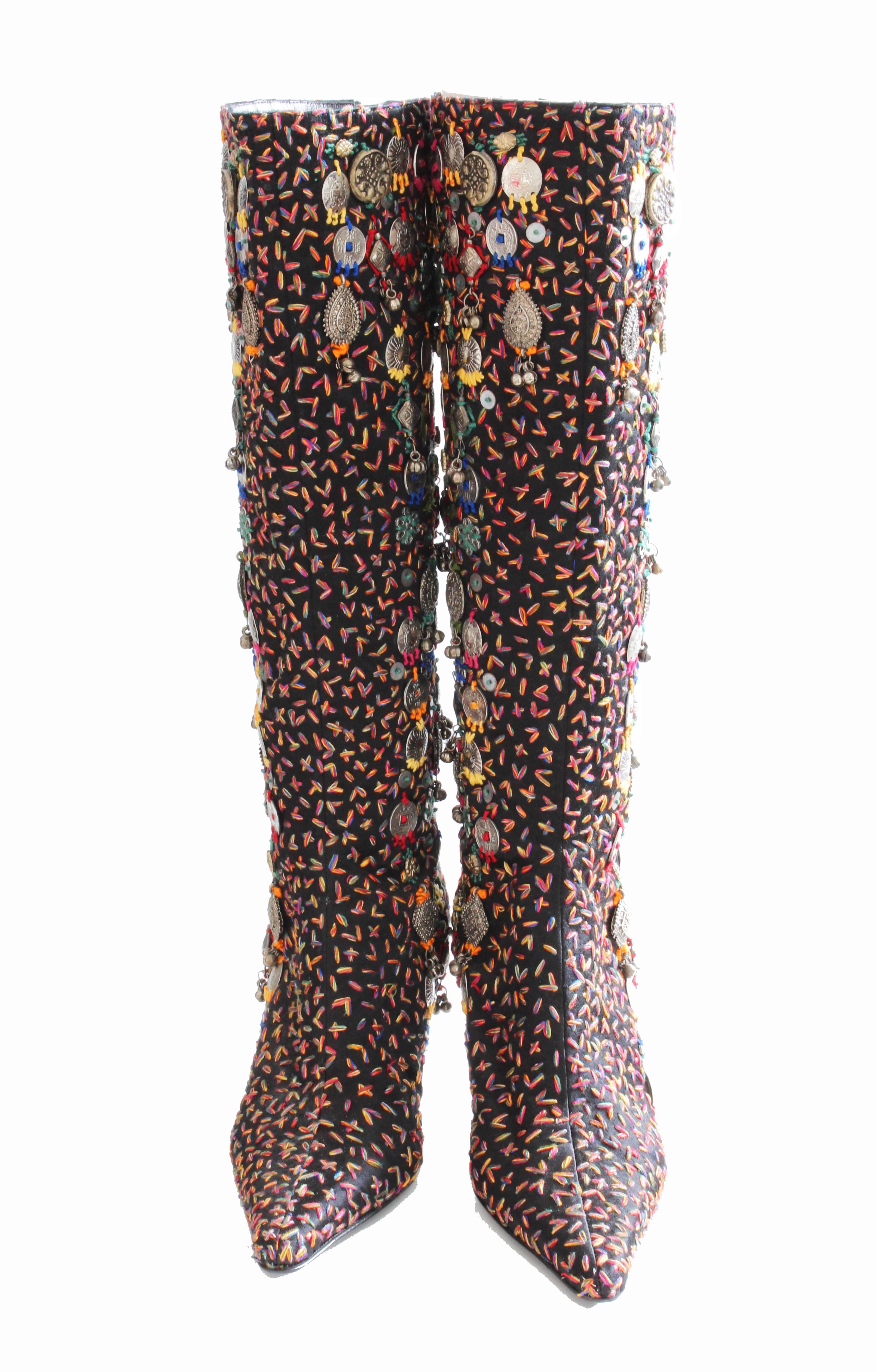 This chic black boots were made by Oscar de la Renta, most likely after 2009.  Made from leather and covered on the exterior with black satin, they feature multicolor embroidery and silver charms, giving them a upscale boho look.  In very good