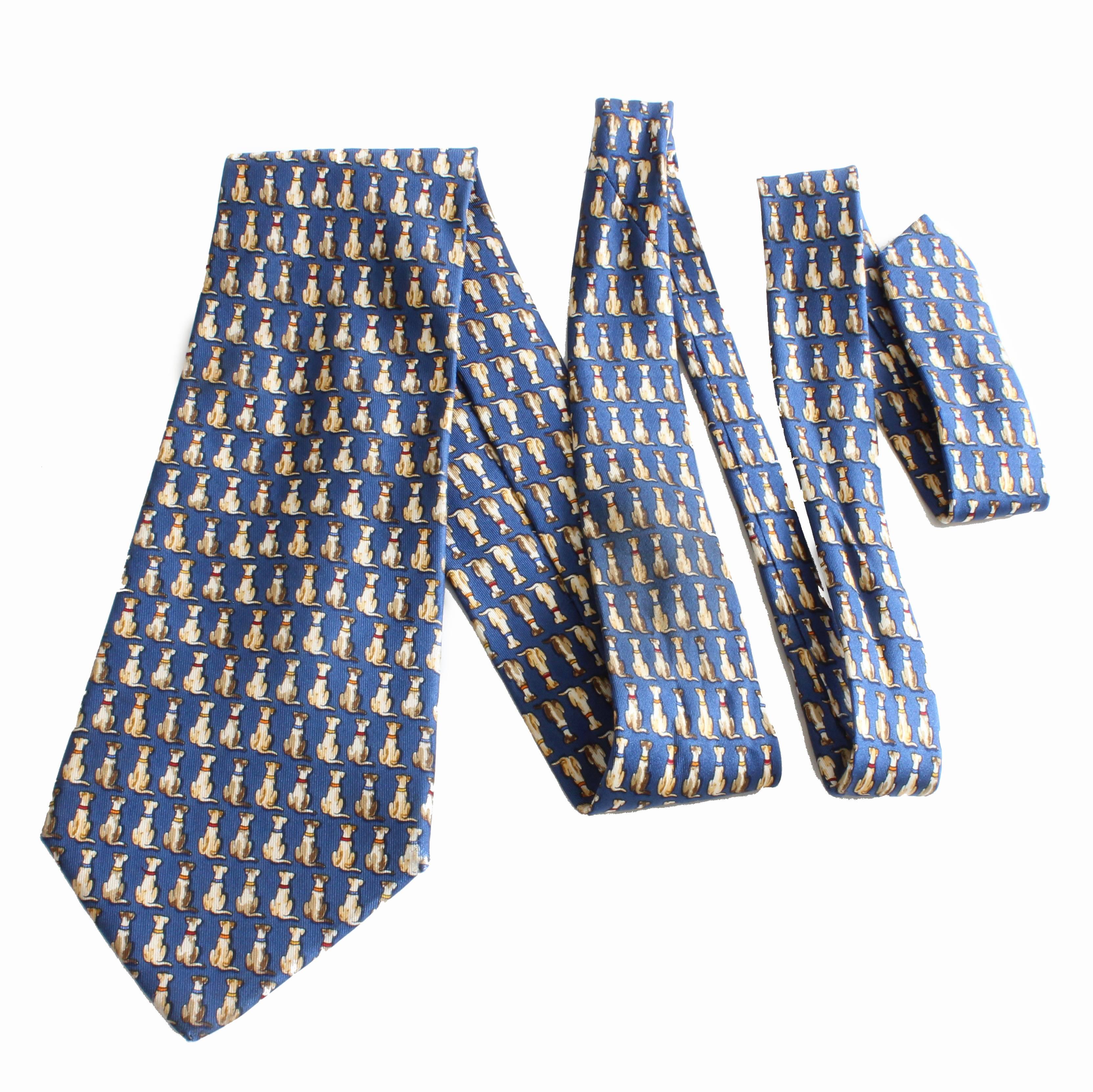 A whimsical tie by Ferragamo featuring sitting dogs.  In very good preowned condition with minimal signs of prior wear.  Tagged SALVATORE FERRAGAMO MADE IN ITALY.