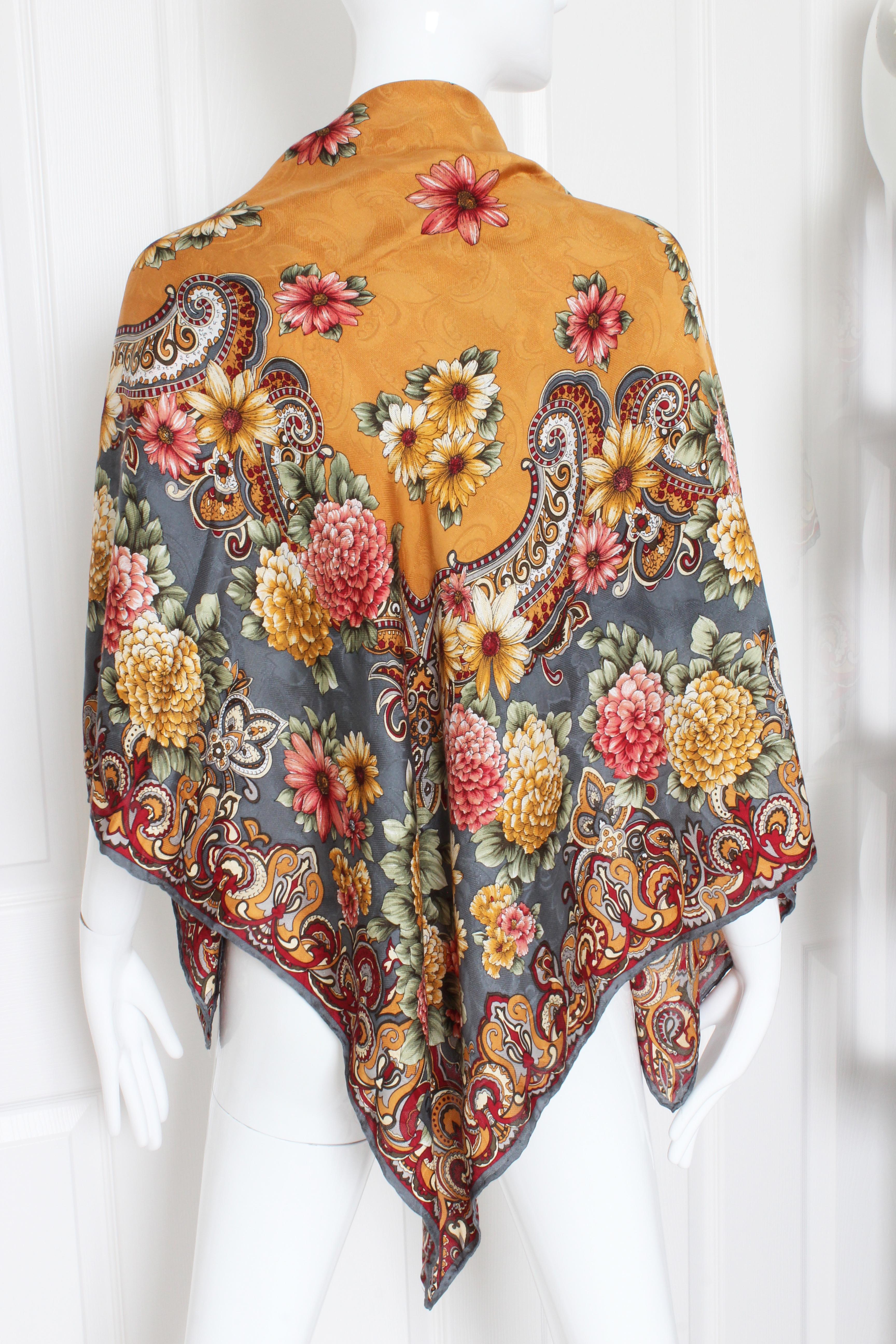 This bold print shawl or scarf was made by Guy Laroche, most likely in the 1980s.  Made from silk jacquard, it features scrolls and floral blossoms throughout.  In good condition commensurate with age, with minimal signs of prior wear and use.  It