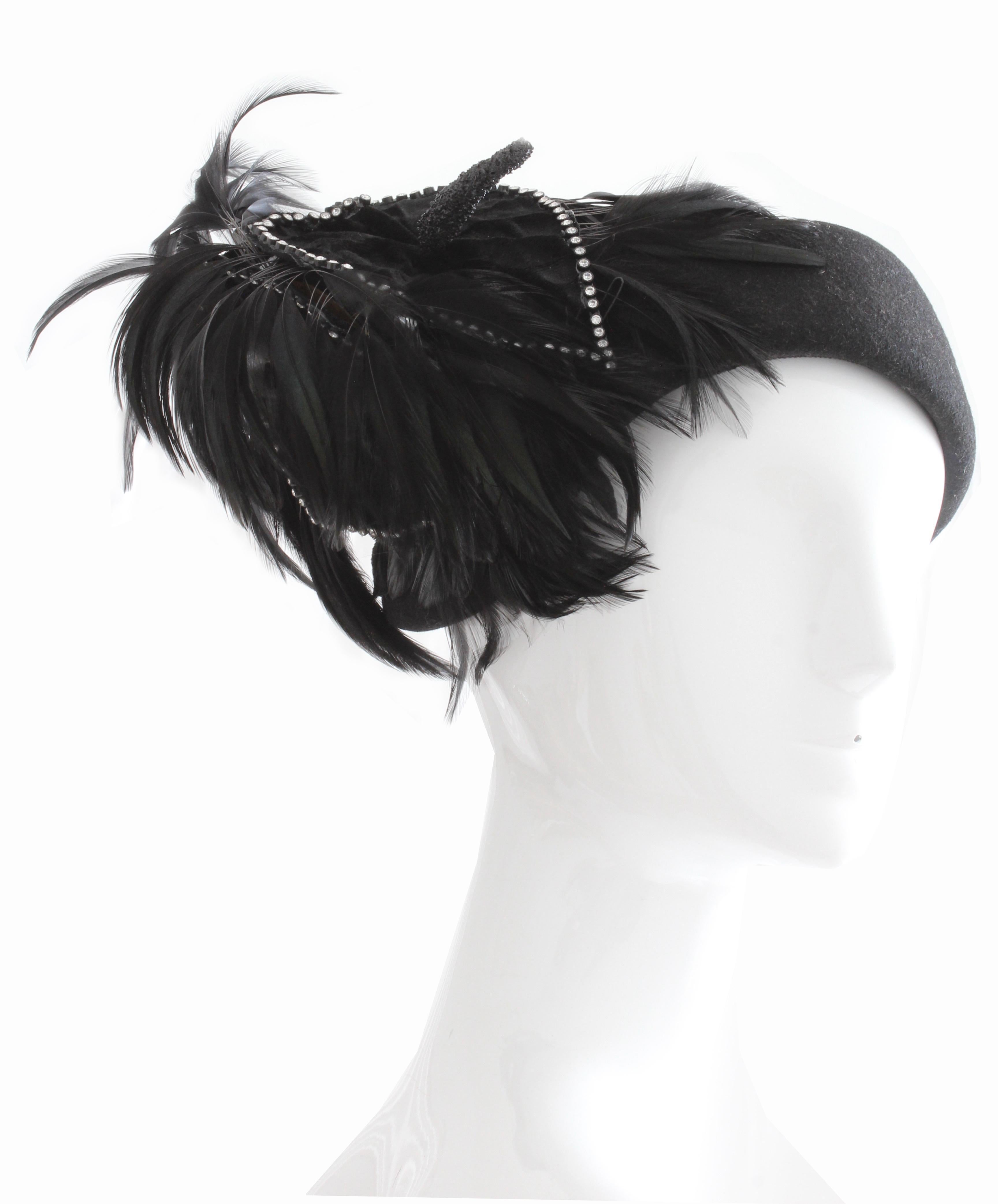 This gorgeous black wool hat with feathers was made by Bollman Hat Co and Jack McConnell, most likely in the early 60s.  Made from black wool, this piece features a decorative velvet covered floral piece that's outlined in rhinestones with