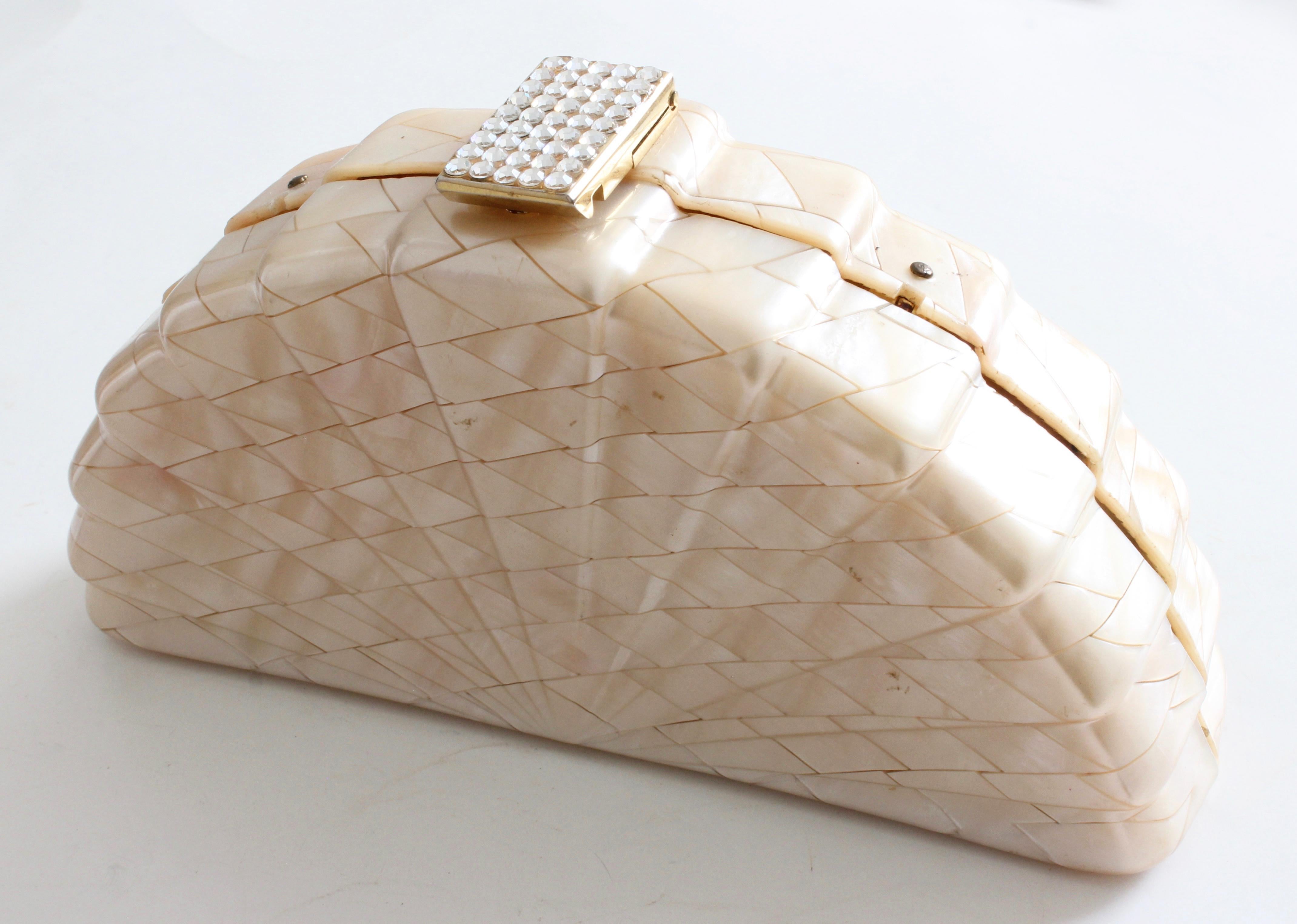 This fabulous little bag was made in Italy for Saks Fifth Avenue, most likely in the early 1960s.  Made from what appears to be highly polished shells in a modern mosaic pattern, this bag fastens with a rhinestone-encrusted latch and features a gold
